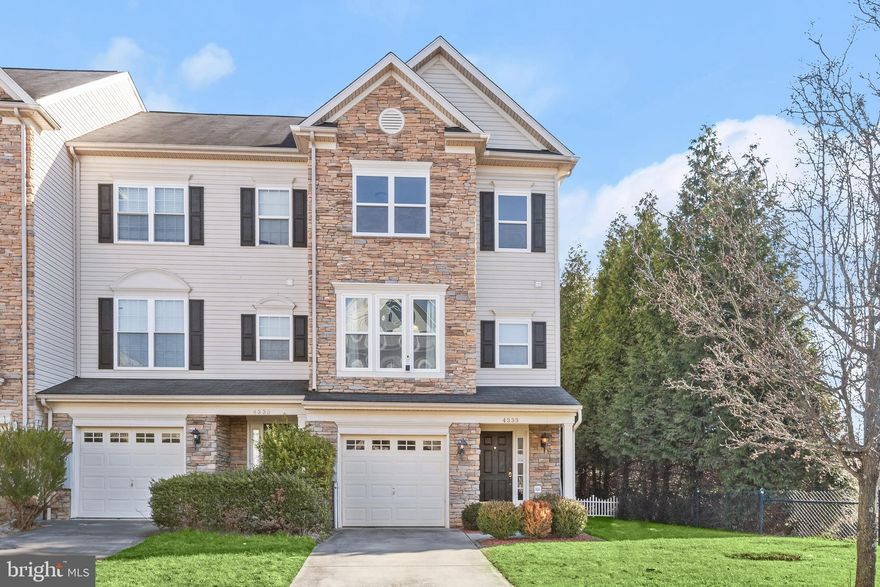 Beautiful, end of row townhome boasts sun filled living spaces with updates including new windows, Nicolock patio, appliances, built-in surround sound Bose speakers, under sink filtration system, storage closet, and more!  A stunning, 2-story rustic stone fireplace is the focal point of the entry level family room that offers built-in Bose speakers and access to the backyard.  Ascend the stairs to the main level that includes a large living room with a ceiling fan, and a sun filled open floor plan that includes the kitchen, dining room, and sunroom.  You'll love preparing your favorite meals in the kitchen that features a peninsula island, light wood cabinetry, and dark grey countertops.  Retire to the primary bedroom suite that offers a large walk-in closet and attached luxury bath with a jetted tub, separate shower and dual vanity. Two additional bedrooms and a full bath complete this level.  Enjoy outdoor living on the patio under mature shade trees.  Just off of 795 and 26 for easy commuter access and nearby Owings Mills offers plenty of shopping, dining, and entertainment options.