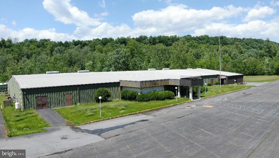 Endless possibilities with this almost 30000 sq ft former Moose lodge. Sitting on 12 acres, use your imagination. Maybe a winery, brewery, or even a wedding venue. With 2 bars, a huge commercial kitchen, stage, dance floor, bowling alley, pavilion, horse pits and even a chicken bar-b-q pit! Make this a destination in central PA