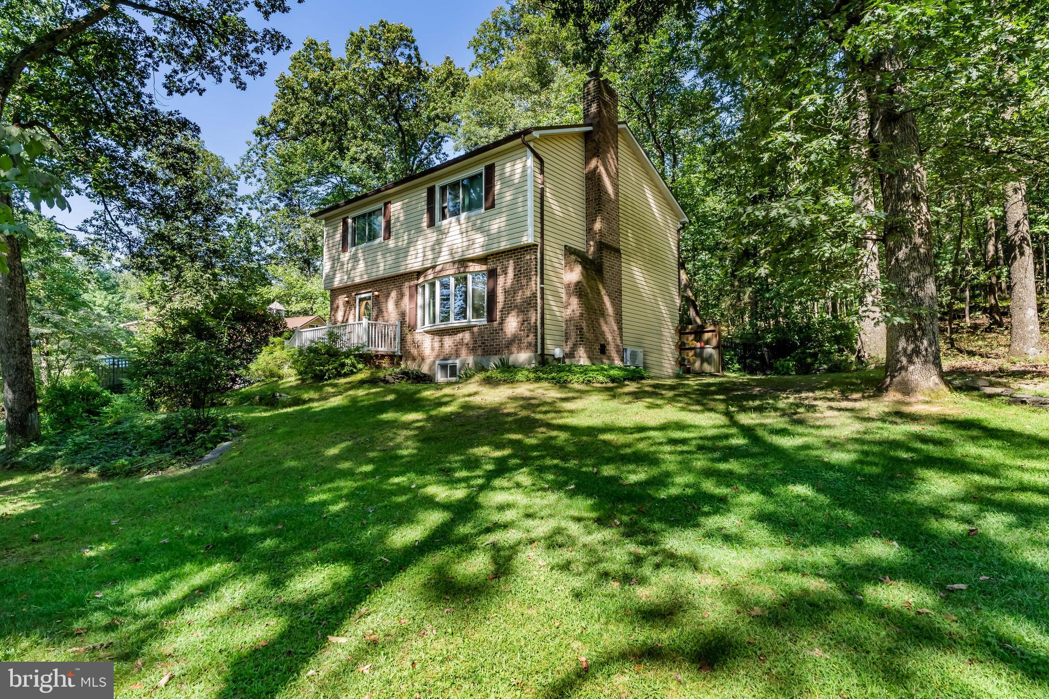 Tucked away on a little over 3 wooded acres, this home offers the peaceful, rural setting you’ve been looking for. With 3 bedrooms upstairs and a 4th bedroom in the fully finished lower level, there’s plenty of space for family and guests. A 5th room on the lower level, with plenty of natural light, offers the perfect spot for a home office, gym, or flex space. Step outside to enjoy the stamped rear patio, small fenced area, and wildlife right in your backyard. The property also features a detached 2-car garage with loft and brand-new metal roof, plus an additional detached workshop with woodstove—perfect for hobbies, projects, or extra storage. With all new Renewal by Anderson windows in Nov 2021, new Leaf Filter Gutter Protection System Feb 2024, new AC mini split summer 2025, and new metal roof on the home and detached garage, everything has been taken care of. Surrounded by mature trees and backing to woods, so much maintenance has already been taken care of, making this is a serene retreat where you can truly unwind.
