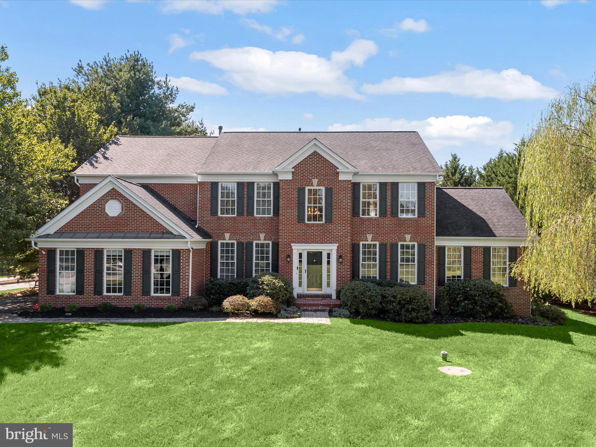 Welcome to 15300 Doe Hill Court, a spectacular Colonial residence tucked away in the prestigious Wellington West community. Brimming with timeless elegance and thoughtful design, this home showcases gleaming hardwood floors on the main and upper levels, along with classic moldings, and sun-drenched interiors that exude warmth and sophistication. Step inside the grand two-story foyer, gracefully framed by formal living and dining rooms adorned with custom trim work. Just beyond, an exquisite sunroom with soaring cathedral ceilings invites you to unwind while taking in serene views of the backyard. At the heart of the home, the eat-in kitchen is a true chef’s delight, boasting granite countertops, decorative tile backsplash, under-cabinet lighting, a generous center island with breakfast bar, sleek appliances, and a stylish butler’s pantry for effortless entertaining. The adjoining breakfast room fills with natural light and opens to the backyard deck, creating the perfect setting for morning coffee or al fresco dining. Flowing seamlessly from the kitchen, the dramatic two-story family room offers an impressive wall of windows and a cozy fireplace, ideal for gatherings both large and small. A private office with French doors, a convenient powder room, laundry room, and direct garage access complete the well-appointed main level. Upstairs, retreat to the luxurious primary suite, a private sanctuary featuring a tray ceiling, generous walk-in closet, and a spa-inspired en-suite bath complete with a soaking tub, glass-enclosed shower, and dual vanities. Three additional bedrooms and two full baths provide ample comfort for family and guests. The lower level is designed for versatility and entertainment, offering a sprawling game room, a bonus area perfect for an additional bedroom or home office, a full bath, and abundant storage space. Outside, discover an outdoor oasis with a tiered deck, custom patio, and secure storage all beautifully landscaped to provide a serene backdrop for outdoor living and entertaining.
