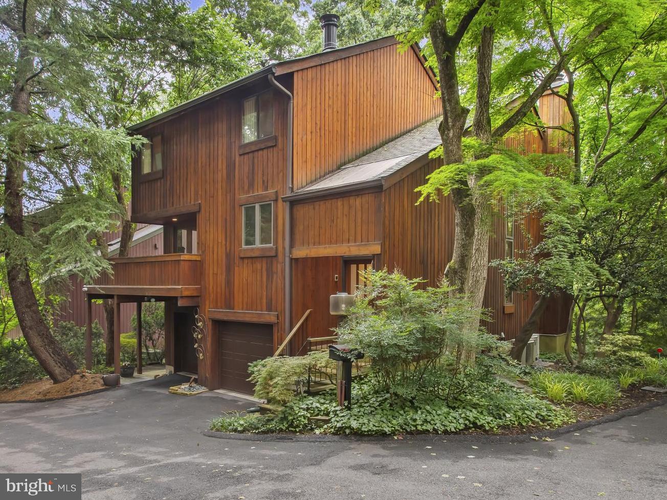 Welcome home! This architecturally distinctive, multi-level contemporary retreat is nestled on a serene private street in the heart of DC’s prestigious Palisades neighborhood. Built in 1978 and thoughtfully designed to maximize natural light and tranquil wooded views, this remarkable home spans over 3,500 sq. ft. across 7 split levels of refined living space. Cathedral ceilings, expansive windows, and skylights flood the interior with light, while three wood-burning fireplaces add warmth and charm throughout. The formal living room opens to a spacious deck, perfect for entertaining, and includes a cozy adjacent wine/card room. The lower-level family room offers seamless indoor-outdoor living with direct access to a private patio surrounded by lush greenery—ideal for quiet mornings or alfresco dining. Additional highlights include a secluded primary suite, multiple entertaining zones, and a unique floor plan offering exceptional flexibility. This pet-free, smoke-fee property, which is being sold by its original owner, has been meticulously maintained and cared for. The pride of ownership is evidenced from the minute you cross the threshold and furthered exquisite care and maintenance with multiple service contracts in place and available for transfer to the discerning buyer. This home was built on the prime lot at the top of the private, heated street (maintained by 8 homeowners at the current annual cost of $600/year). Enjoy life in this tranquil, wooded setting just moments from parks, the C&O Canal, and vibrant MacArthur Boulevard amenities.