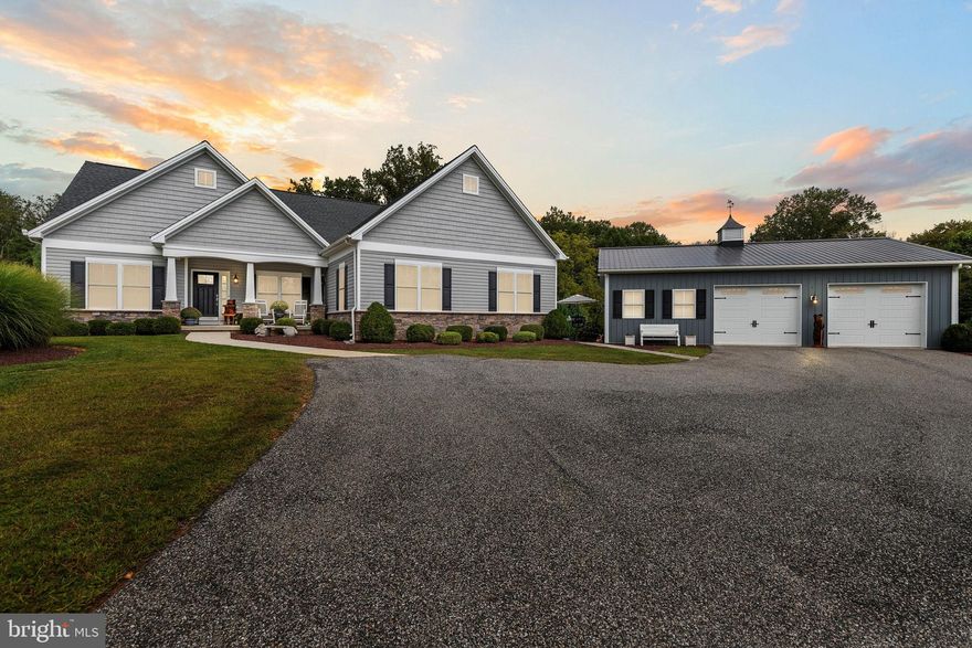This versatile home with separate living quarters offers comfort, style, and modern living on one level, with additional finished basement space. Step into the bright and inviting living room, featuring hardwood floors, chair rails, crown molding, recessed lighting, a ceiling fan, and a cozy gas fireplace. The open dining area flows seamlessly from the living room and leads to a small deck, perfect for morning coffee or outdoor entertaining. The chef’s kitchen is the heart of the home, featuring gray granite countertops, a large island with a farm sink, 42-inch custom cabinetry, and upgraded stainless steel appliances, including a French-door refrigerator. The main level also includes two well-appointed bedrooms with hardwood floors, double-door closets, plantation shutters, and a full bath with tile flooring and a tub/shower combo. The spacious primary suite is a private retreat with hardwood floors, a barn-door walk-in closet, a tray ceiling, and a spa-like bath featuring stone tile flooring, dual vanities, and a stylish walk-in shower. Laundry hookups are conveniently located nearby. The partially finished walkout basement adds a massive amount of living space, including a recreation room, powder room, craft room, and abundant storage. A true highlight of the property is the fully equipped in-law suite, offering complete, independent living with its own entrance, it's own HVAC system, family room, full kitchen with granite countertops and stainless steel appliances, bedroom with double-door closet, jack-and-jill bath with walk-in shower, and a second laundry hookup—perfect for multigenerational living or long-term guests. Outside, multiple decks, a huge detached garage with full electric and workshop, a large pole building, and sprawling acreage provide endless possibilities for hobbies, storage, outdoor entertaining, and enjoying every season. Built in 2017 and meticulously maintained, this home combines modern amenities, timeless charm, and incredible versatility.