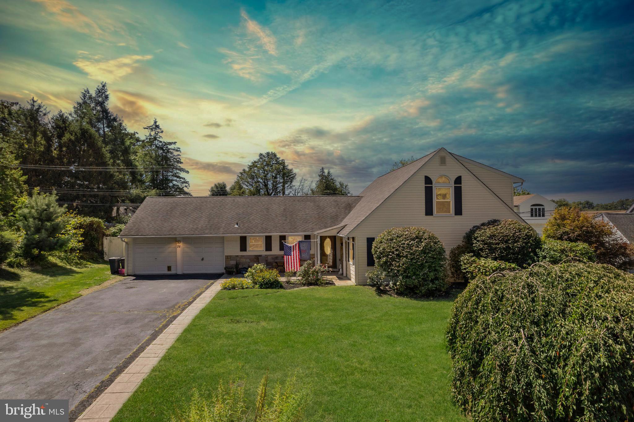 Set in the desirable Forsythia Gate section of Levittown, this expanded Country Clubber has been lovingly owned by the same family for over 45 years and is ready for its next chapter. Offering up to six bedrooms and three full baths, including a private primary suite on the main level, this home delivers exceptional space and flexibility for today’s lifestyle. A stylish, modern kitchen anchors the main level with white shaker cabinetry, granite countertops, stainless-steel appliances, breakfast bar and a classic subway-tile backsplash, opening to a sunny dining room with large bay window and an inviting living room highlighted by a brick fireplace. On the second level you’ll find three additional bedrooms and one full bath, ideal for guests, a home office, or multigenerational living. Outdoors, the wide driveway and oversized two car garage add practical storage, while the covered paver patio and level yard create the perfect setting for gatherings or quiet evenings at home. Recent exterior updates including newer siding, replacement windows, and central air provide comfort and curb appeal year-round. Located within the highly regarded Neshaminy School District and close to shopping, dining, and major commuter routes, 75 Flamehill Road blends classic Levittown charm with tasteful updates and a rare six-bedroom layout.