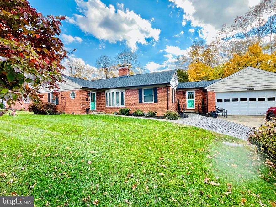 Welcome to 1108 Hampton Garth — a charming 4-bedroom, 2.5-bath brick home in Towson’s prestigious Hampton community.

Renovated in 2025, this home features a new roof with solar panels, a fully updated primary bathroom, and a new sump pump. Major upgrades completed in 2022 include a new central A/C system, hot water heater, and attic insulation (2023). Smart Ring and Nest systems add convenience and security.

The main level (1,714 sq ft) offers three bedrooms, including a spacious primary suite, and two full baths — one newly renovated and very chic. A well-appointed kitchen with tile flooring opens to a dining room with a working fireplace, a laundry area, and a sunroom overlooking the expansive backyard. Solid wood floors run throughout, including the sunroom. The home also features two front entrances and direct access from the kitchen to the garage.

The partially above-ground lower level adds over 1,000 sq ft of finished, flexible living space with three separate walk-out entrances to the backyard. It includes a bedroom with full windows, a large rec room with a second working fireplace, a half bath with natural light, and two bonus rooms — ideal for a home office or gym. A custom cedar walk-in closet and generous storage space complete the lower level.

Step outside to a parklike setting just shy of half an acre, with custom stone terracing, a stone walkway, and an 8-person hot tub (included). Stacked firewood is also included — enough to fuel both fireplaces for the season.

Hampton is known for its spacious lots, mature landscaping, and timeless architecture. Its proximity to top-rated hospitals and universities makes it especially appealing to medical professionals, educators, and families. Just minutes from downtown Towson, the home offers easy access to shopping, dining, cultural venues, and schools. Outdoor enthusiasts will love nearby Loch Raven Reservoir, Cromwell Valley Park, and the Hampton National Historic Site.

This Hampton gem won’t last long — plan your visit today!