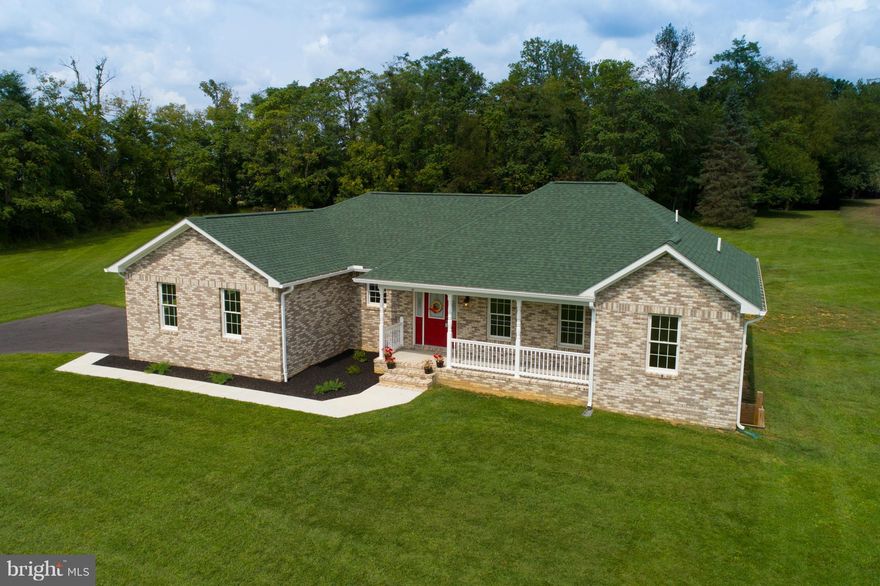 MOVE-IN READY! 3 bedroom 2 bathroom rancher with split floor plan set on a 2 acre lot! Beautiful hardwoods throughout, hickory cabinets, and knotty pine vaulted ceilings. The huge master suite features a large en suite master bathroom, connecting walk-in closet with wood built-in storage, and private access to the rear deck. propane furnace. Stainless steel appliances; propane cooking & heating.