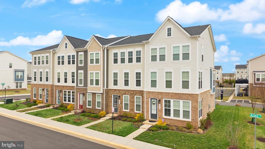 Beautiful 3-bedroom, 2 full and 2 half bath townhome with a rear-entry two-car garage in the highly desirable Robinson Manor community in Gainesville, VA. Built by Van Metre and thoughtfully designed for modern living, this spacious three-level home features an open floor plan filled with natural light and stylish upgrades throughout. The main level offers a large living, dining, and kitchen area perfect for entertaining, highlighted by recessed lighting, luxury vinyl plank flooring, and a bright modern kitchen with white cabinetry, quartz countertops, stainless steel appliances, cooktop, double wall oven, built-in microwave, tile backsplash, and a large center island. A sliding glass door leads to a generous composite Trex deck, ideal for outdoor dining and relaxing. The upper level features a spacious primary suite with multiple windows, a walk-in closet, and an upgraded bathroom showcasing double vanities, beautiful tile work including a herringbone accent, a large walk-in shower with bench, and stylish finishes. Two additional bedrooms, a full hall bathroom, and a convenient top-level laundry area complete the upper floor. The entry level offers a welcoming foyer, a comfortable recreation room, and an additional half bath perfect for guests or flexible living space. Additional highlights include recessed lighting throughout, ceiling fan pre-wiring in bedrooms, plenty of windows for natural light, oak stairs, and a large two-car rear-entry garage. Robinson Manor residents enjoy fantastic community amenities including walking trails, parks, tot lots, clubhouse, pool, and community gathering spaces. Conveniently located near major commuter routes, shopping, dining, and everything Gainesville and Northern Virginia have to offer, this home provides the perfect combination of comfort, style, and location. A great opportunity for buyers searching for a Gainesville VA townhome, Robinson Manor home for sale, or Northern Virginia home with modern finishes, and community amenities.