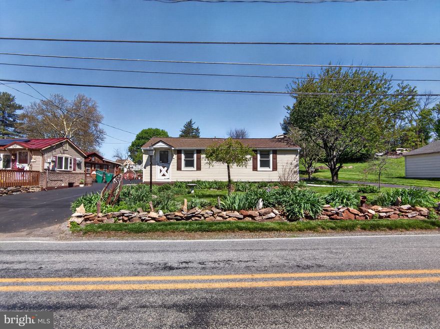 East Penn School District detached home set on a property with a unique wraparound driveway and an impressive two story oversized detached garage offering exceptional space for vehicles, storage, hobbies, or workshop use. The garage is a standout feature and provides versatility that is hard to find. Inside, the home offers a practical layout with a main floor bedroom and a full bathroom with a walk in accessible shower. The eat in kitchen includes a pantry closet and connects conveniently to the mudroom and laundry area for everyday functionality. The living room features classic wood paneling that adds warmth and character. Zoned heating provides comfort and efficiency throughout the home. Outside, the property also includes a chicken coop and storage shed, offering space for gardening, small livestock, or additional outdoor storage. A great opportunity to own a detached home in the East Penn School District with unique outdoor space and flexibility for a variety of uses.