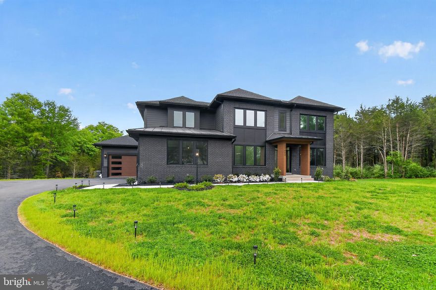 Exceptional almost 7000 sq ft  Light-Filled Estate on 2.5+ Private Acres in Poolesville — No HOA! Welcome to this stunning turn-key, move-in ready home nestled on over 2 private acres backing to woods and conservation land, offering the perfect blend of luxury, privacy, and modern convenience. With room for a custom pool (already permitted) and a generous backyard ready for your vision, this property offers resort-style living at home. Designed with a custom elevation and filled with thoughtful upgrades throughout, this light-filled home showcases expansive windows, sun-drenched living spaces, and an open floor plan ideal for both everyday living and entertaining. From the moment you enter, you’ll appreciate the wide-plank hardwood floors, spacious layout, and quality craftsmanship, with too many upgrades to list. 
The heart of the home is the gourmet kitchen, featuring quartz countertops, stainless steel appliances, extra-wide 42” refrigerator, oversized walk-in pantry, breakfast bar, sunroom, and lanai, creating a seamless flow for gathering and entertaining. A kitchen sink water filtration system adds an extra touch of convenience. The main level also features a bright private office with a custom mural, plus a flexible bonus room that can serve as a main-level bedroom or additional living space.
The oversized mudroom leads to an attached 3-car garage plus additional 4th garage bay, complete with an electric vehicle charging station, offering incredible functionality and storage.
Upstairs, the luxurious owner’s suite is a true retreat with his and hers walk-in closets, a spacious spa-inspired ensuite, private sitting area perfect for a study, TV room, or yoga studio, and a private lanai to enjoy morning coffee with peaceful views. Four additional generously sized bedrooms and three full baths provide abundant space for family and guests. The fully finished walk-up lower level expands your living and entertaining options with 2 additional bedrooms, full bath, gym/theater room, large recreation room, and a wet bar with refrigerator and dishwasher hookups. Perfect for remote work and modern living, enjoy ultra high-speed FiOS and an unbeatable location just minutes to three MARC train stations, with easy access to Rockville, Gaithersburg, Washington DC, Leesburg, and Frederick. Located in the heart of charming Poolesville, known as one of Maryland’s best small towns and home to the award-winning Poolesville High School cluster, this exceptional property offers the rare freedom of NO HOA along with space, privacy, and community.
Light-filled, beautifully upgraded, and designed for both luxury and lifestyle—this extraordinary home truly has it all.
