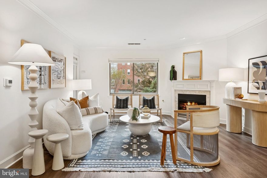 This turnkey home at Ballston Park offers comfortable living in one of Arlington's most desirable neighborhoods. The spacious living-dining room features upgraded wide plank flooring, a gas fireplace with marble surround and painted wood mantle, crown moulding, and recessed lighting. Enjoy its western exposure from the balcony overlooking a quiet, private courtyard – perfect for a glass of wine at sunset. The kitchen with breakfast bar has stainless steel appliances, a gas range,  and plentiful storage and prep space. Both bedrooms have large walk-through closets with ensuite bathrooms, with the primary ensuite offering both a walk-in shower and a separate oversized soaking tub for maximum relaxation. All expected modern conveniences are present including recently upgraded central heating and air conditioning (2023), and new in-unit washer and dryer and water heater (2024). TWO side-by-side garage parking spaces and additional storage convey. Ballston Park is an amenity rich building with a gracious lobby, fitness center, party room, and on-site property manager. Pet friendly community (25 lb weight limit). Ballston Park is just steps to the new Ballston Quarter offering destinations such as Ted’s Bulletin, Compass Coffee, Jinya Ramen Bar, OneLife Fitness, Regal Cinemas, and Union Kitchen. This north Arlington location is just minutes to DCA and a brief Metro ride into the District.