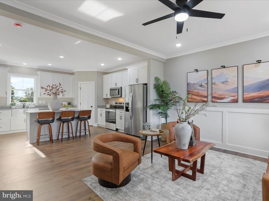 Major price reduction! Custom built two story Colonial on almost a half acre in southern Berkeley County with no HOA! The main level boasts a huge living room that opens to the beautiful gourmet kitchen with white soft close cabinets, island, pantry, and plenty of table space. The dining area opens to the rear deck that has steps to the back yard.  There is a main floor office, powder room, and mud room area off the 2 car front load garage. The finished garage contains a 10' ceiling. The entire main floor consists of 9' ceilings, luxury vinyl plank flooring, crown molding, chair rail, shadowbox, and custom window and door trim. Upstairs, the primary bedroom contains 2 walk in closets, primary bathroom has a tub shower and double vanity with granite countertops. The other 3 bedrooms contain walk in closets and bedroom two has it's own full bathroom with tub shower and granite counter top. There is also another full guest bathroom with tub shower. Downstairs, feel free to finish for more living space and add another bathroom as there is rough in plumbing; otherwise there is plenty of room for storage. The home contains a 2 zone heating and air system for extra comfort. The exterior has vinyl siding, beautiful stone accent, and cedar shake siding over the garage. The lot is flat and the back yard has plenty of room for an inground pool! Located close to shopping, schools, restaurants, and I 81 for those commuting to VA or MD. Please see the standard and upgraded feature list in the uploaded documents.