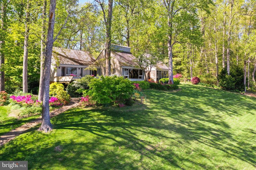 Adjacent waterfront lot available to purchaser for $275,000! Welcome to 1363 Wilton Creek Road, a distinctive waterfront retreat where timeless architecture meets natural elegance, designed in 1975 by architect Bob Borum, inspired by Hugh Newell Jacobson, crafted with rough-sawn redwood siding, a cedar shake roof, and copper gutters. Step through cherry chevron double doors into a great room with soaring vaulted ceilings, exposed rafters, teak flooring from Thailand, and a floor-to-ceiling cupola blending architecture with nature, while picture windows frame panoramic views across the Piankatank River to Stove Point and Gwynn’s Island. Smooth redwood walls, a Buckingham slate foyer, and a gas fireplace add warmth, with a loft offering a whimsical nook for kids. The eat-in kitchen, with concrete countertops aged to a soft patina, is perfectly positioned for river views. The owner’s suite, a sanctuary with a pine-walled den salvaged from Richmond’s Westham Train Station, features river views, a walk-in closet, and an ensuite bath with a frameless glass shower, leading to a screened porch with slate flooring and exposed beams, connecting to a brick patio for outdoor dining. The guest wing includes two bedrooms with a shared Jack-and-Jill bath and a cozy deck with built-in benches for sunrise views or morning coffee. Outdoors, enjoy a private beach, a 324' pier with lighting, a 10,000 lb boat lift, fish cleaning station, 50 amp shore power, swim ladder, a full-size tennis court, and an outdoor shower. Vast majority of furniture and furnishings convey. This one-of-a-kind home offers refined waterfront living with architectural pedigree.