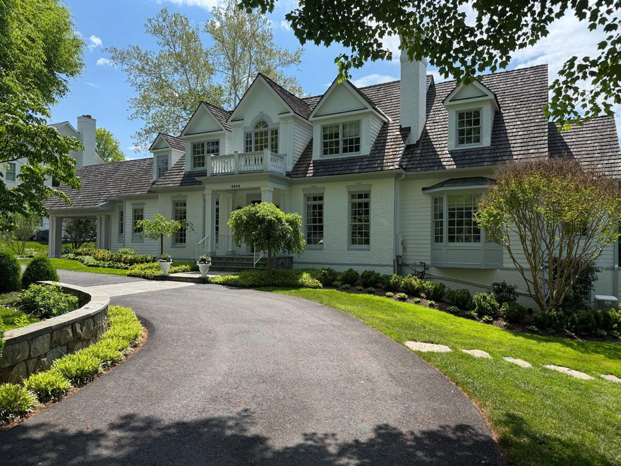 Nestled in the prestigious Langley Forest, this exquisite Colonial residence offers a harmonious blend of luxury and comfort, perfect for those who appreciate the finer things in life. This home is designed for both entertaining and everyday living, featuring six spacious bedrooms and six full bathrooms, complemented by three elegant half baths. As you step inside, you are greeted by a warm and inviting atmosphere, accentuated by rich hardwood floors. The open floor plan seamlessly connects the family room, adorned with a stunning stone fireplace to the paneled library and gourmet kitchen. This culinary haven boasts upgraded countertops, a large island, and an open concept butler's pantry. The kitchen is equipped with high-end appliances, including a double wall oven, cooktop, and a built-in refrigerator, ensuring that every culinary endeavor is a delight. The main level also features a large, bright breakfast area and a formal dining space, perfect for hosting dinner parties. The main level also features one of two primary suites. Venture outside to discover your personal oasis. The expansive backyard is designed for entertaining, featuring extensive hardscaping, a BBQ grill, outdoor kitchen, hot tub and pool, all set against the backdrop of a beautifully landscaped lot. The multiple patios and covered porch provide serene spots to enjoy the outdoors. This home also includes a fully finished basement with a walkout level, offering additional living space that can be tailored to your needs, including a kitchen, media room, exercise room, sauna and wine closet. With three attached garage spaces and a circular driveway, parking is both convenient and accommodating. The upper level of the garage offers a wonderful au pair, guest or in-law space. This residence is not just a home; it's a lifestyle, offering an unparalleled blend of luxury, comfort, and convenience in one of the most sought-after neighborhoods. Experience the elegance and warmth of this exceptional property, where every detail has been thoughtfully crafted for your enjoyment.