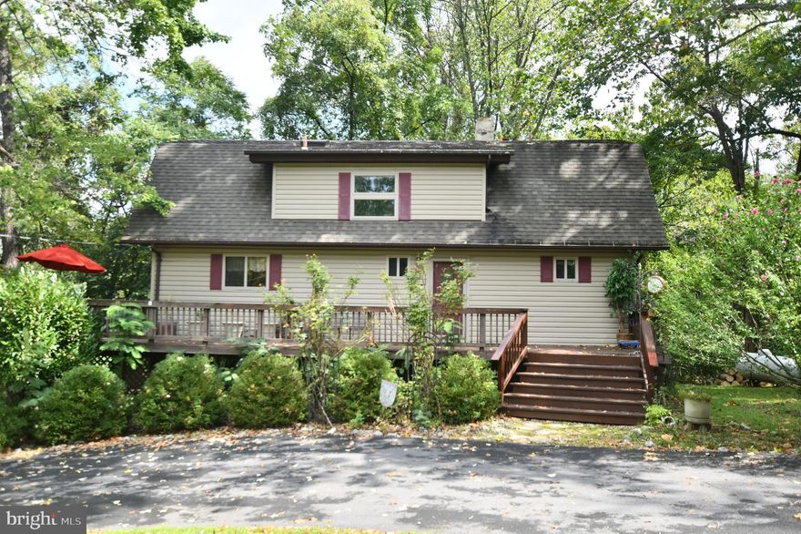 Three finished level home on almost an acre offers lovely wooded views from the wraparound decking!  Serene, Apple Mountain location with ability to walk to community lake! Hardwood flooring through the two story living room & dining room - Main level bedroom w/ private bathroom - Finished, walkout basement w/ family room, stone hearth & wet bar - Kitchen w/ 42" cabinetry & stainless steel appliances -In need of some cosmetic work but upgrades include new windows and doors!   Whole house generator conveys - Don't miss the 2 car detached garage's upper level! Asphalt roads to the home and recently constructed circular driveway - Easy access to Route 66!  One year home warranty in place upon request!