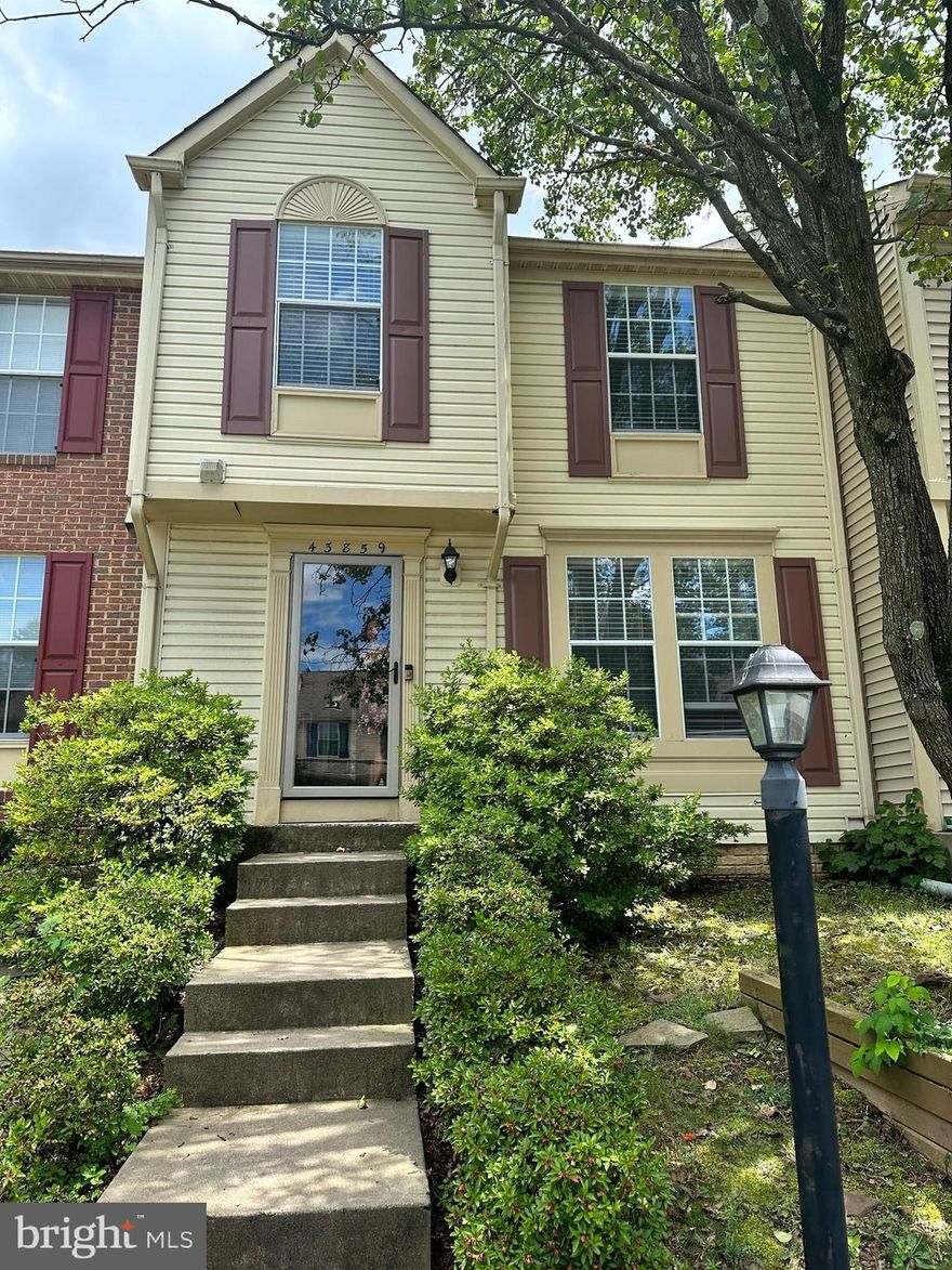 Beautiful 3 level townhome - 2 master bedrooms upper level with its own full bathroom, 1 Full Bath in basement and 1/2 bath on main level, Hardwood floors on main level, Large deck with stairs and 2 assigned parking spaces.