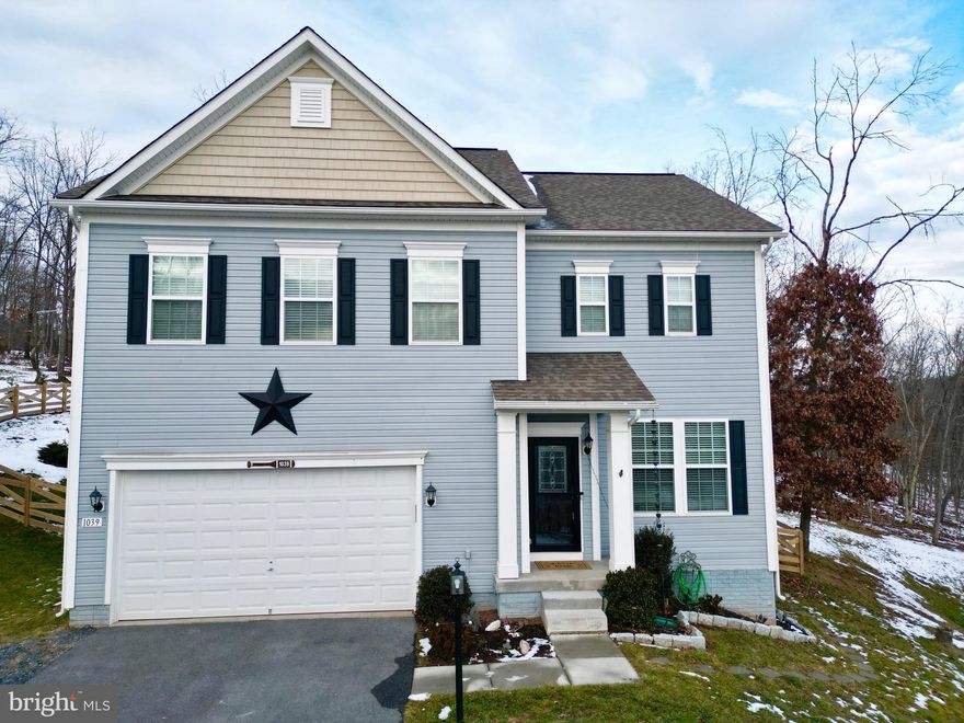 Price Improvement!! There is so much to love about this huge home on the hill. All new KitchenAid appliances in the kitchen with a beautiful island, morning room, separate dining room, kitchen opens to living room for great entertaining. Just off the morning room is the sliding door to the new retaining wall, landscape beds and patio on the large lot that will offer hours of relaxation and extended entertaining room.  There are 2" blinds throughout the home along with a security system and Xfinity High Speed Internet through service provider. Garage entrance, mud room and 1/2 bath are more features of the main level.  Upstairs boasts 4 spacious bedrooms, hall bathroom and large laundry room with washer and dryer conveying. The spacious primary bedroom offers a massive walk-in closet and ensuite. Last but definitely not least is the newly renovated basement ($30,000 total renovation cost). The basement offers a bedroom, office, living pace, bath and full kitchen with washer and dryer conveying. All of this space offers your overnight guest, family or rental income potential the best in their own private space. This community offers so many amenities and close proximity to Winchester with 24 hour gate security. The lake and beach areas, walking trails, sports courts, dog park, disc golf and clubhouse enables you to live like you are on vacation! This home in this exclusive community is a must see!