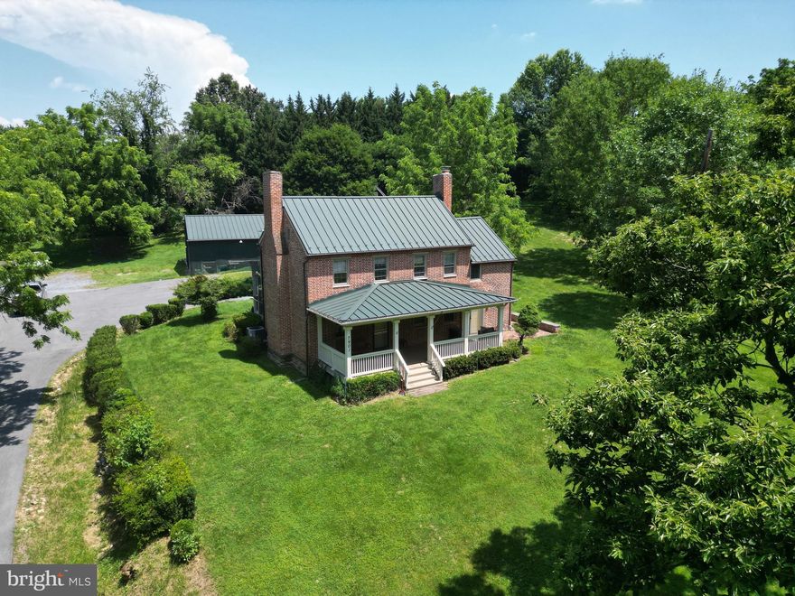 Discover a one-of-a-kind retreat just 9 miles from Rio Washingtonian Center: Montgomery County's Historic John T. Warfield House located at 7901 Warfield Road sits majestically on 5.71 lush acres, marrying timeless antiques with today’s comforts. Inside, lovingly preserved antique hardwood floors flow through spacious living areas accented by tasteful modern updates. The solid brick exterior and enduring metal roof promise low-maintenance living, while brand-new HVAC and water-heater systems ensure year-round comfort. there’s an two private suites with its own entrance, bathroom and bedroom, parking for 10+ cars, two fully wired workshops and a large electric-connected storage shed—ideal for hobbyists or weekend projects and a playhouse with a loft. Don't miss your chance to own this extraordinary blend of heritage charm and contemporary convenience. 
— Listed by Fernando Mejia of The ONE Street Company