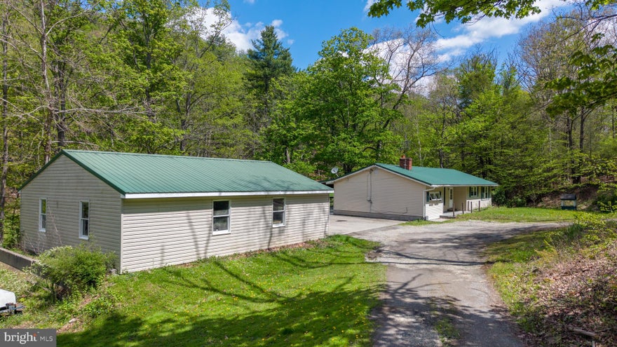 This charming ranch-style home is ready for your personal touch and creative vision. Offering over 1,200 square feet of living space, the home features four bedrooms and one full bathroom on the main level—perfect for those seeking single-floor living with room to grow. A full, unfinished basement is a blank canvas for the creative mind. Set on a beautiful 2.75-acre lot, the property provides a peaceful, private setting complete with a small stream winding through the land—ideal for enjoying nature right in your own backyard. A detached two-car garage adds convenience and additional storage space.