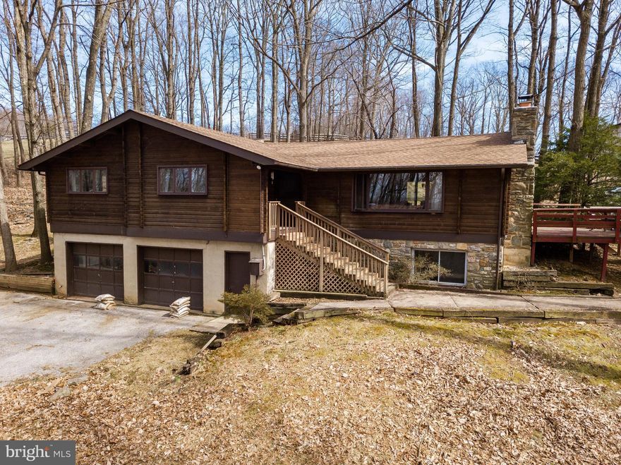 Owner motivated to sell this secluded farm with incredible views! This is an excellent opportunity to own two deeded lots in Mt. Airy totaling 22.8 acres complete with a cozy 3 bed/2 bath log cabin home. The roof is new and the basement is partially finished and plumbed for a third bath. The property also boasts a six-stall barn with water and electric and an additional two stall run-in shed. A bluestone outdoor riding arena, close access to trails, and 17 acres of open pasture make this farm the perfect choice for an equestrian.