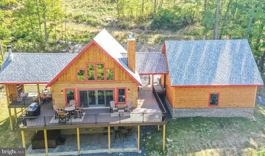 The most private home in North Camp! Special is an understatement when it comes to this 5BR, 4.5BA custom-built mountain masterpiece WITH garage! Perfectly placed on oversized 3.34 acre lot, BEYOND the end of an already private cul-de-sac, you'll find Parhelion Chalet in all of its splendor. All by its lonesome and overlooking a gorgeous mountain view,  every feature of this home was designed to blend into the treetops and amplify the amazing outdoor experience. Mountaineer Log Home design and built by Joe Dixon, one of the most sought-after builders on the mountain. Features include multiple master suites, gourmet kitchen with Amish made cabinetry, rec room with pool table & games, built-in bar w/ automatic
icemaker and mini fridge, spacious wrap-around trex deck, fire pit, covered porch outdoor living area with fireplace, hot tub, Tesla universal charger, state of the art electronics and pre-wired for sauna. Home is currently a successful vacation rental with a growing fanbase - repeat rentals and rising income. High quality contents and custom imported furnishings, 3 total fireplaces (2 wood), ample storage in garage and multiple owner closets.