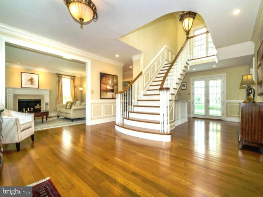 Elegantly designed and masterfully handcrafted of the finest quality materials this magnificent estate manor home has a majestic presence on a highly desirable street in Bryn Mawr. Brimming with appeal, and exquisitely appointed with custom millwork, every room is an invitation to gracious living. An architecturally stunning central staircase is the focal point of the welcoming foyer filled with natural light, and lustrous hardwood floors. It allows a beautiful view of the splendid spacious living room with floor to ceiling windows and fireplace surrounded by marble and a grand carved mantle.  A classic, large dining room with gorgeous crystal chandelier is served by an adjacent butler's pantry complete with sink, wine refrigerator, and pantry closet. The expansive open floor plan includes a lovely family room with huge two story windows, bi-level ceiling, gas fireplace and built-in bookshelves, a wonderful sunny morning/breakfast room with doors to the patio, and a fabulous gourmet kitchen featuring  a center island of stunning granite with seating for four. The kitchen also includes a six burner gas range, double ovens, ceiling height cabinetry, and abundant granite counters and storage space. A divided light glass door leads to small room with access to the back porch, and pool area. Completing this floor is a splendid library/study with built-in bookshelves and french doors to a patio, two powder rooms and a mudroom with exit to the three car garage.  Upstairs enjoy a private retreat in the main bedroom with two walk-in closets and sumptuous marble bath having two vanities, large whirlpool tub, separate shower, and WC. Additionally, there are two bedrooms with private baths, and two bedrooms with adjoining bath, and a full laundry room.  A full stairway leads to an unfinished 3rd floor with expansion possibilities.  The enormous finished lower level serves as office, play and media room, with a full bath, an impressive gym with special flooring, and additional storage. Outside, the professionally designed and landscaped backyard features a free-form pool with waterfall spa and provides resort luxury and outdoor entertainment for family and friends. This outstanding property is located within minutes of major roads, award winning schools and universities, public transportation and shopping. Offering every amenity for the discerning buyer it is truly suburban living at it's best. At current price it is the best home for the money in Radnor