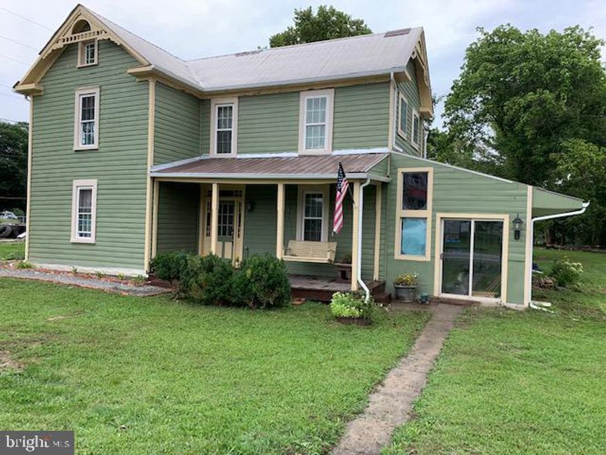 4BR 1 BA home in Great Cacapon, just 5 miles from Berkeley Springs. Closet off Main level Bathroom is designed for a 1/2 bath to be added.   Picture yourself relaxing on the front porch swing  as your neighbors pass by.   Main level features a foyer, bedroom living room, eat in kitchen, adjoining laundry room wih room for storage, heated work shop and unheated sun room.  Upper level has an additional 3 bedrooms, one with a balcony for private getaway and a full bath.  Spacious back yard for games, play or a garden.