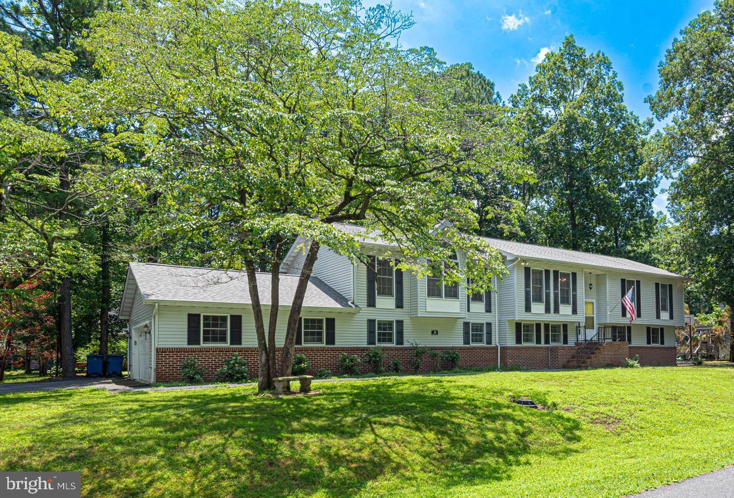 Spacious and versatile 6-bedroom, 4-bath home situated on an oversized 11,553 sq. ft. corner lot in the amenity-filled community of Ocean Pines! Recent improvements include a new roof (2024) and updates to the kitchen and primary bath. This well-maintained property offers excellent potential for multi-generational living or rental income—with the upper level estimated to rent for approx. $2,800/month.
To accommodate separate tenants, the interior staircase has been temporarily enclosed, allowing each level to function independently. The seller is happy to remove the wall and restore the original layout at the buyer’s request. This setup also works beautifully for hosting guests or offering a private space to extended family or young adults.
The home includes two primary suites with private baths, two spacious family rooms, and great outdoor features like a rear deck for grilling and entertaining and a basketball pad on the side of the home. A partially floored attic adds extra storage, and there’s a 2-car garage for convenience. A one-year home warranty is included for peace of mind.
Enjoy all that Ocean Pines has to offer—pools, parks, golf, marina, beach club, and more—in this spacious and flexible home that’s ideal for year-round living, vacationing, or investing!