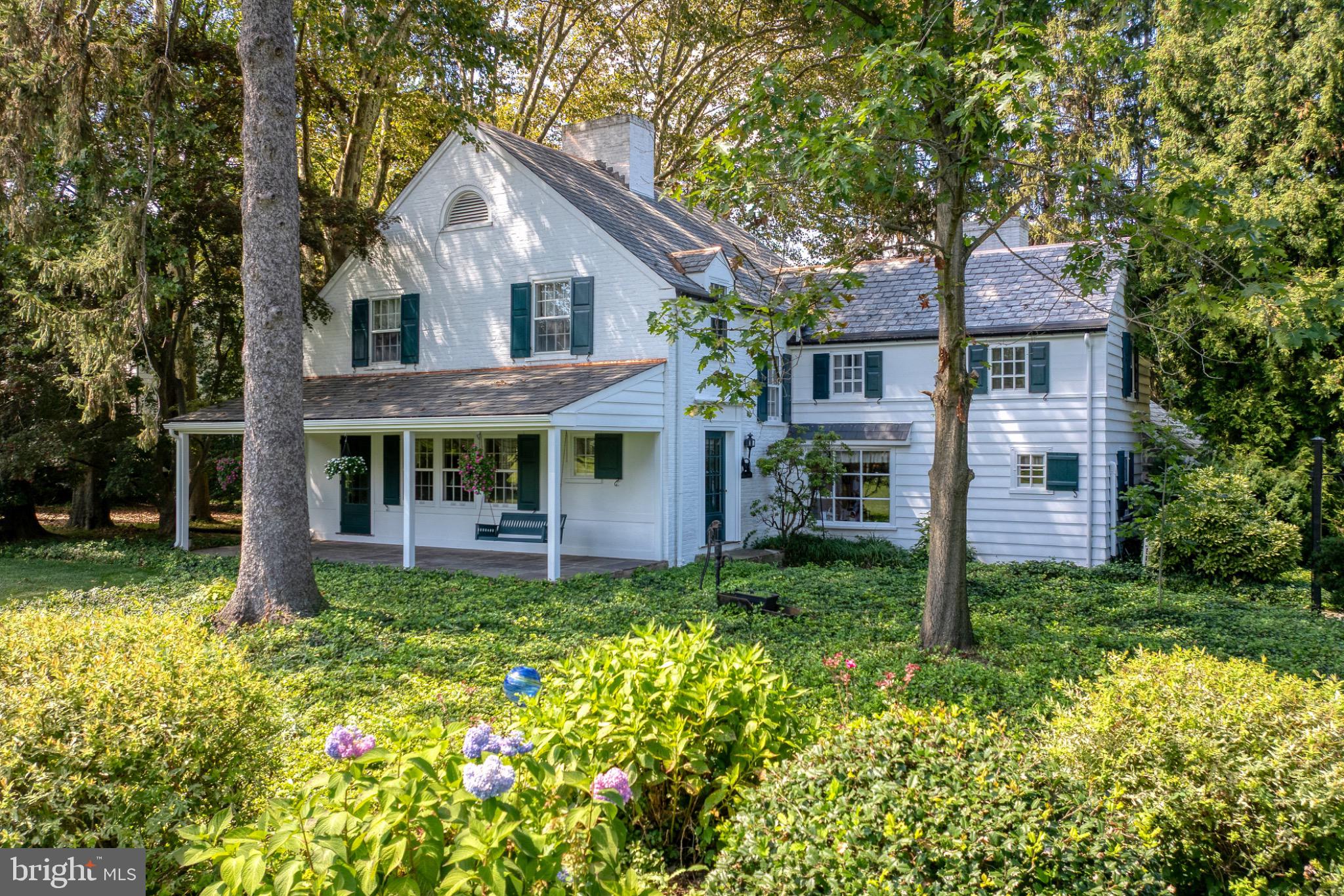 Tucked off Millersville Pike in Lancaster Township, this 1939 English cottage-style estate offers a desirable combination of charm, privacy, and flexible living spaces. The property includes the main home, a private apartment, and two additional building lots on Bentley Lane—altogether totaling 2.39 acres. The lots are available for any builder, giving buyers the option to develop or simply retain them as the current owners have done to enjoy privacy and abundant outdoor space. A circular driveway welcomes you into this private retreat. The main home features 2,936 square feet and the apartment is an additional 740 square feet. The home includes 4 bedrooms, 2 full and 2 half baths, and four fireplaces. The family room offers built-ins, a fireplace, and access to the patio—an ideal spot to relax or entertain. Recent improvements include a newly replaced slate porch roof, fresh interior and exterior paint, and a tuned-up slate roof with new copper flashing. Above the oversized two-car garage, you’ll find a one-bedroom apartment complete with a living room, full kitchen, bath, laundry, and private entrance. This versatile space is close by yet completely separate—perfect for extended family, guests, or rental income. The fenced yard, flagstone courtyard, large shed, and beautiful surroundings add to the property’s appeal. With its inviting character, flexible spaces, and unmatched setting, this home is best experienced in person.