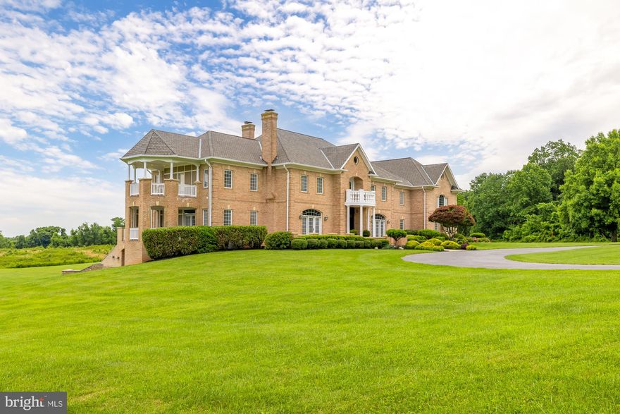 Experience unparalleled luxury in this breathtaking custom estate, nestled on 20+ pristine acres of lush greenery in the exclusive enclave of Spring Meadows. As you step into the grand 2-story foyer, you are greeted by exquisite marble flooring and a dazzling Schonbek Crystal Chandelier that sets the tone for opulent living.

The heart of this home is the magnificent 2-story great room, where a cozy gas fireplace provides a perfect gathering spot for family and friends. Adjacent to the great room, the breakfast room leads to a chef’s dream kitchen. This culinary masterpiece is adorned with granite countertops, custom cabinetry, skylights, decorative lighting, double ovens, a SubZero refrigerator, a walk-in pantry, and a convenient desk area. The kitchen is flooded with natural light from three large windows which offer picturesque views of the property. 

The formal living and dining rooms feature impeccable granite flooring, recessed lighting, and intricate moldings, exuding elegance at every turn. The main level also boasts a spectacular sunroom with two sets of French doors. One set leads to a covered terrace offering breathtaking views of a neighboring lake. The other set opens to a spacious terrace, complete with a built-in gazebo, perfect for outdoor entertaining. Additionally, found on this level is a mudroom, a full bath with terrace access, a spacious laundry room, and a sideload four-car garage. All four HVAC systems have been replaced in the last 18 months.

As you ascend to the upper level you are greeted with a luxurious owner’s suite designed as a true retreat from everyday stresses. This sanctuary features a gracious sitting area with a dual-sided gas fireplace, wet bar, and access to a private east-facing covered terrace. The opulent ensuite bath includes a jetted tub and fireplace, while the spacious dressing room is fitted with custom built-ins for shoes, sweaters, purses, and ample drawer and hanging space. Additionally, the second floor offers four more generously sized bedrooms with ensuite baths, two bonus rooms, and an office with custom Wood-Mode built-ins and wet bar.

On the fourth level, you’ll find two versatile finished rooms offering an array of options for additional offices, art studios, or extra storage. 

The expansive lower level is truly an entertainer’s paradise, featuring a newly renovated recreation room with a fireplace, a theater room, a custom wet bar with a wine refrigerator, an exercise room, a billiards room with a fireplace, a large game room, a generous guest suite, and a bonus room. Direct access to the large backyard and loggia with an outdoor bar adds to the functionality of this space.

This estate encapsulates luxury and leisure, providing every amenity for a sophisticated lifestyle. With over 20 acres of serene landscape to call your own, this property is truly a sanctuary of refined living. Indulge in the ultimate estate experience just outside the city, where every detail is designed for elegance and comfort.

All measurements are approximate. Property details and square footage should be independently verified.