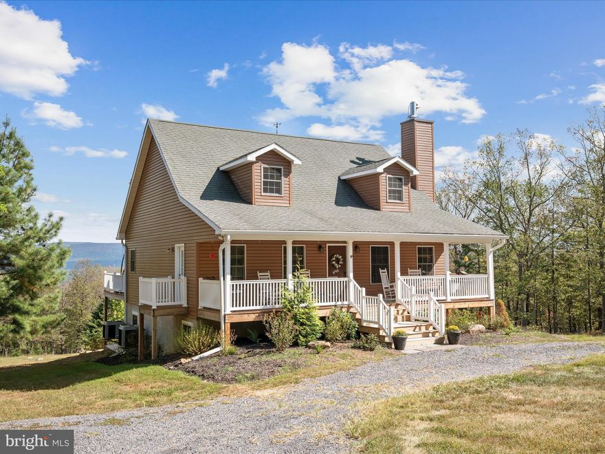 Experience refined mountain living with this stunning 30.17-acre estate, where modern comfort meets the unmatched beauty of West Virginia’s landscape. Designed in 2008 as a weekend retreat and later cherished as a permanent residence, this property blends elegance, privacy, and panoramic mountain views into a one-of-a-kind offering. Step inside this 4BD/3.5BA home to discover a thoughtfully finished walkout basement, complete with multi-use space great for home offices, a full bath, and additional living space ideal for hosting family and guests. The main level impresses with soaring ceilings, a striking wood-burning fireplace, and a gourmet chef’s kitchen outfitted for both everyday living and effortless entertaining. The primary suite is a true retreat with its own spa-inspired ensuite, while a convenient half bath and main-level laundry add ease and practicality.
The top level offers additional bedrooms and another full bath, along with a private balcony where you can take in sweeping views of the wild and wonderful West Virginia mountains. Outdoors, flourishing fruit trees and cleared grounds set the stage for curated landscaping, gardens, or simply enjoying the natural beauty in complete seclusion—no neighbors in sight. Perfectly positioned, the property is only 20 minutes to the charming town of Wardensville with its local shopping, dining, and vibrant organic farmers market, and just 30 minutes to Winchester, VA, for expanded conveniences. This is more than a home—it’s a mountain sanctuary designed for those who seek both sophistication and solitude. Schedule a private tour today and make this exceptional estate your own.