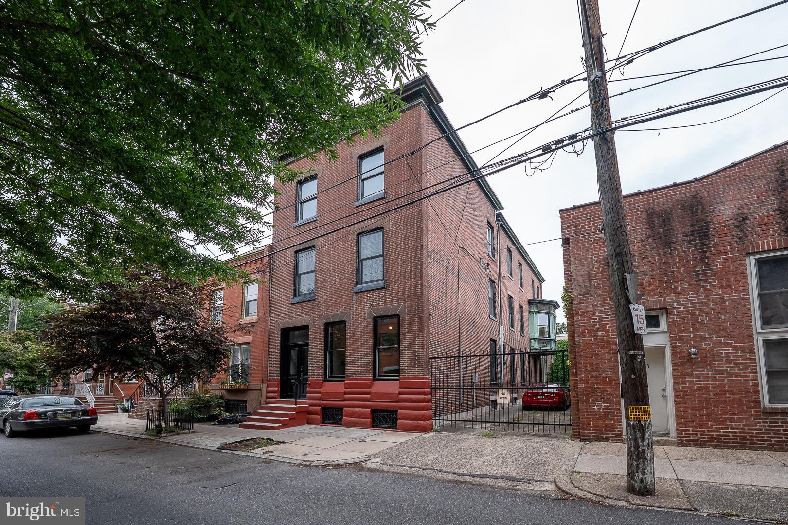 This is a truly unique opportunity to own an exceptional, character-rich home in the sought-after Art Museum neighborhood. Boasting 4 bedrooms, 2.5 baths, and approximately 3,900 square feet of living space, this residence (which is zoned RM1) has the potential to be a multi-family property; or add a rental unit; or have a large office with a residence above! It can be customized to your own taste as it combines original architectural charm with modern conveniences — including a 2-car Garage plus a driveway which accommodates 3 cars for rare, off-street parking! The foyer welcomes you with an original ceramic tile vestibule, charming tin ceilings, classic wainscoting, and original wood floors, all anchored by a stunning staircase. The foyer entry leads to a huge office or flex space with its own private entry showcasing soaring ceiling height, original moldings, and side-facing windows that flood the room with natural light. An adjoining room includes an old-fashioned fireplace plus a half bath, making it ideal for many functions such as a private office, creative studio or additional lounge area. On the second floor, you’ll find a grand living space showcasing the original pine floors, high tin ceilings, and a large copper bay window that opens to an expansive deck —perfect for entertaining, relaxing, or urban gardening. The kitchen, complete with stainless steel appliances and a breakfast bar, seamlessly connects to this space. One generously sized bedroom and a bathroom complete this floor. The third level offers a spacious sun-soaked corner bedroom with a walk-in closet, a large hall bath with a classic clawfoot tub, a middle bedroom (currently used as a laundry room), and a spacious front bedroom, all showcasing the home’s timeless charm and functionality. Additional features include three-zone heating and cooling (one for each floor); solar panels for energy efficiency; and an expansive unfinished basement for storage or potential development. Located just steps from Kelly Drive, the Philadelphia Museum of Art, and the vibrant shops and cafés of the Art Museum District, this home offers the perfect blend of historic beauty, space, and location.