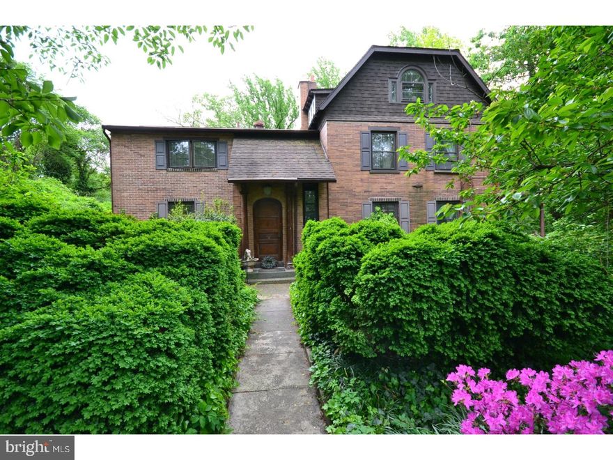 Simply Extraordinary one of a kind home in a magical woodland setting on a private lane. Beautifully positioned just 3 blocks from the Train Station and Lansdowne's Shopping District!  This stately countrified all brick home is beautifully highlighted by Leaded Glass Windows, Beamed Ceilings, Hardwood Floors throughout. The character filled Center Hall opens to the huge Living Room with an absolutely fabulous Inglenook Fireplace flanked by book cases and accented with leaded glass windows.  The Living Room has glass doors opening to the deck overlooking the very big back yard and Pennock Woods. The Bird Sanctuary and Dog walking trails are below this wooded area on your way to the Creek meandering thru the woods. Large Formal Dining Room and the sunny, updated Eat in Kitchen leads to the beautiful all year round secluded Sun Room with wonderful wooded views. Exit from the kitchen to the deck and gardens; there is also a door to a small Covered Porch and a private parking spot. Second Floor:  The Sun Filled Master Bedroom is huge and has two seating areas. There is a spacious Master Bathroom. Three additional Rooms and Hall Bath and the Third Floor is home to 2 Delightful Storybook Rooms in the eaves.  The Basement is Full and partially finished (in law suite). 2 Car Garage and additional private parking!
