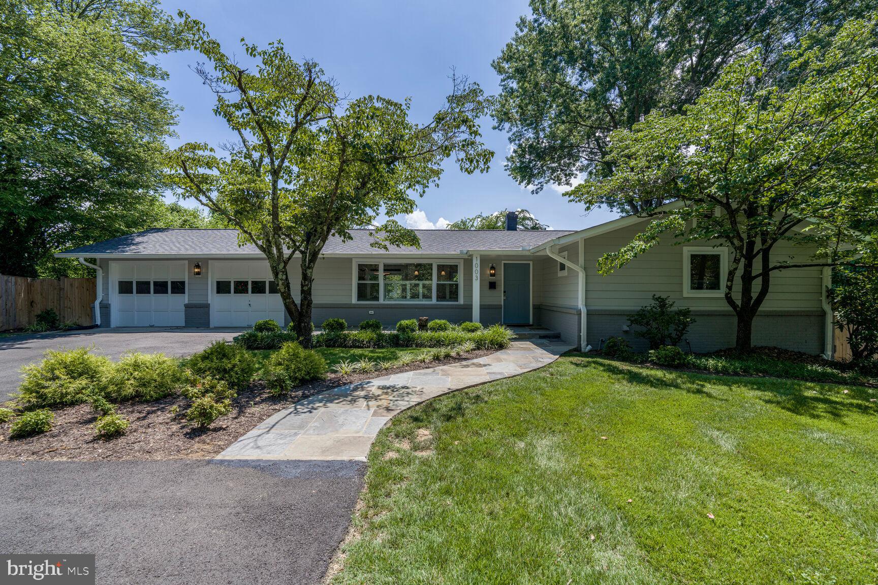 Welcome to 1003 Collingwood Road, a gorgeous, raised rambler with tons of recent upgrades sited on a pretty 3rd of an acre lot in Alexandria’s sought after Collingwood on the Potomac! This home has great curb appeal with its charming white picket fence, curved flagstone walkway covered front porch. There’s an open contemporary floorplan with beautiful white oak hardwoods, plantation shutters plus recessed lighting & double-pane vinyl windows throughout. The charming living room has a large window bringing in lots of sunlight. There’s also a cozy fireplace with a brick surround and a detailed wood mantel. The modern home office with its vaulted ceiling and skylight is the perfect place to work from home. The stunning kitchen has been designed with the chef and home entertainer in mind. It has a Miele 6-burner stove, range hood & dishwasher and a Fisher & Paykel refrigerator. The kitchen also features quartz countertops, a sleek subway-style tile backsplash and a large island with an overhang for barstool seating. Step out the sliding glass door to the spacious Trex deck perfect for grilling out with family & friends. The beautifully manicured big backyard also has a brick patio & retaining wall with steps down to the side yard. There are 3 spacious bedrooms on the main level and 2 tastefully updated full baths that have been stylishly reimagined with all the latest wish-list items. The owner’s suite has 3 closets and a window that overlooks the lovely rear grounds. The lower level features the 4th bedroom and the terrific rec room with wide-plank flooring and lots of recessed lights. There’s also a bathroom with floor to ceiling tile in a herringbone pattern. This amazing home is conveniently located off the GW Parkway for quick access to Alexandria, DC, Fort Belvoir & the Pentagon!