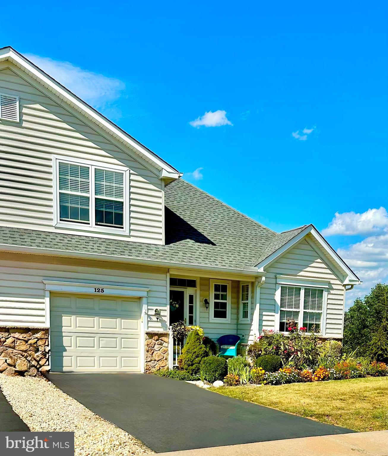 Welcome to 125 Haslan Lane in the Villages of Hillview, an active 55+ community in Chester County, PA. Situated on a premier hillside cul-de-sac lot, this carriage/twin-style home offers beautiful views from the first-floor bedroom, wraparound deck, and downstairs walk-out patio.
This bright, welcoming home is ready for you to move in and enjoy! The main level boasts an open, easy-to-navigate floor plan with a primary bedroom suite with remodeled bathroom —perfect for comfortable, single-level living. Upstairs, a second bedroom with its own full bath provides a cozy space for guests or visiting family.
The expansive uniquely finished basement adds even more living space with a second fireplace, a custom wine cellar, and a bar area ideal for gatherings and holiday celebrations. A dedicated Maker/Creator room provides endless options for hobbies or crafts, or quiet workspace. An additional utility room and extra storage space make it easy to keep all the things you don’t want to part with when transitioning into your new home. Distinctive beams and posts—repurposed from the original farm buildings once on this property—add character and a touch of history to the lower level. From the walk-out patio, you can relax and enjoy peaceful views of the open space and local wildlife.
Life at Hillview is more than just low-maintenance living-it’s a lifestyle. Affordable HOA fees provide access to recreational amenities, clubs, and community events that make this neighborhood one of Chester County’s most sought-after active adult communities.
Features & Updates include:
New roof
New heater and air conditioner
Remodeled main bathroom
Added granite countertops, cabinetry, and kitchen island
Crown molding throughout main floor
New vanity in Powder Room
Added cabinets in laundry area and garage
Built-in bookshelves and cabinetry in sun room
Installed transom windows above main bedroom door and sun room entry
Added upstairs fireplace
Custom wine cellar
Maker/Creator room
Built-in racks and cabinets in unfinished utility area
Bottom of Form