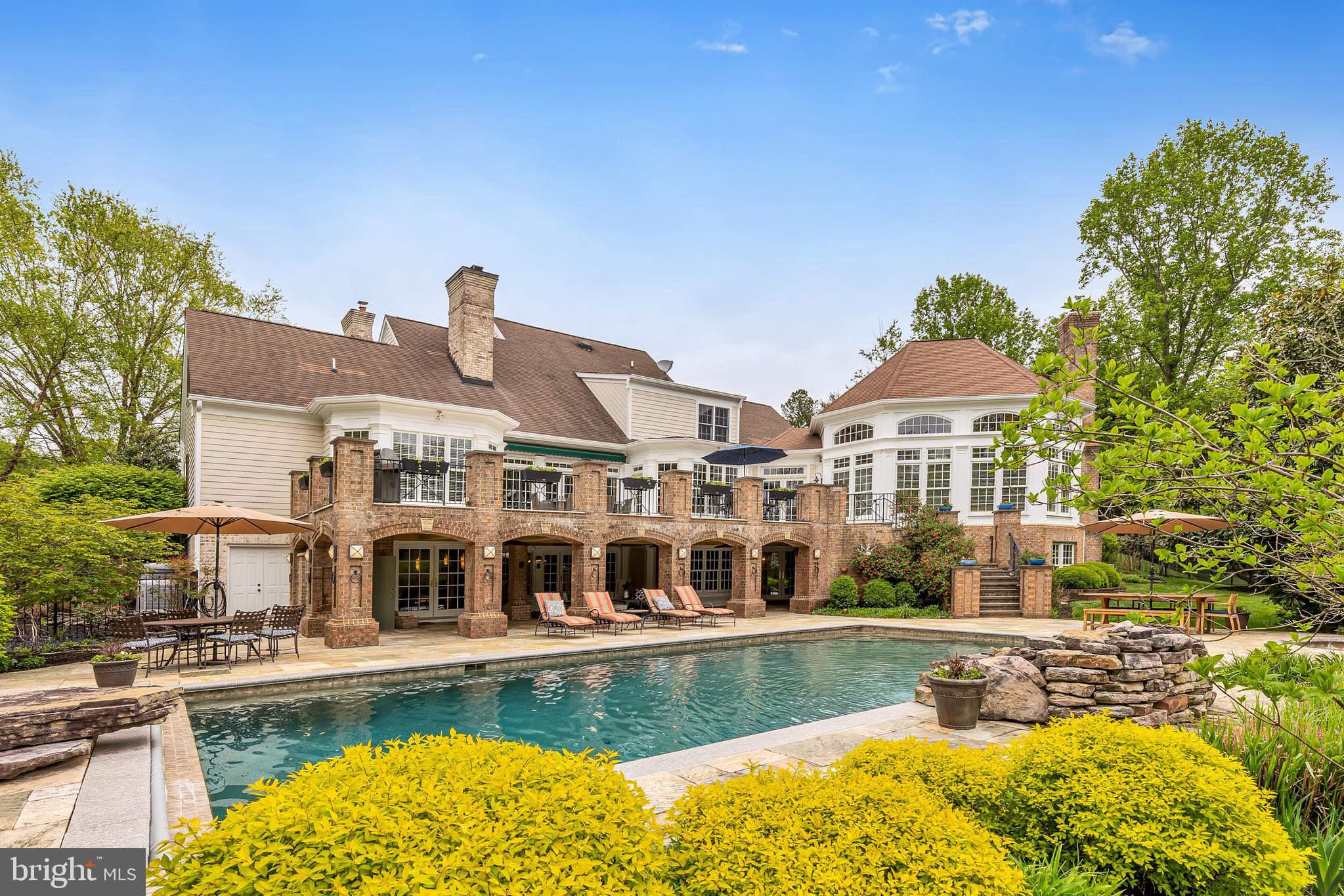 This sophisticated Southern Living property embodies luxurious outdoor living and entertaining. Settle in and celebrate the start of summer in the coveted Ivy Reach community! Host your first party alongside the stunning heated saltwater pool (complete with a retractable cover, stone fountain, and stone diving board), surrounded by Travertine decking and a built-in hot tub. Get some shade under the covered patio, where you can relax while your favorite music pipes through the speaker system, then duck into the outdoor shower to be fully refreshed!
Designed for entertaining, your guests can access the walkout finished basement from the pool area or take the bluestone steps up to the second tier of the outdoor living space, an expansive Travertine deck with space for a crowd and a gorgeous view of the grounds! Benefit from the privacy and beauty of the owner's investment in extensive hardscaping, professional landscaping, and fencing of the backyard.
This property provides 6,800 square feet of beautiful finished living space. If you've been seeking a luxury home with the highest caliber of construction that's completely turnkey, you've found the one! Beaming with natural light, lovely millwork, custom built-ins, four Rumford fireplaces, and a fantastic floor plan design with rooms that are just the right size. The crown jewel of the interior of this home is the jaw-dropping timber-framed sunroom. This sun-drenched space is simply spectacular, and it will be so cozy to curl up here next winter alongside the floor to ceiling stone fireplace.
Other top features of this home include the bright great room with a vaulted ceiling and yet another charming fireplace, and the chef's kitchen which is complete with stainless appliances, quartz countertops, double ovens, and a 6 burner gas cooktop. The main level owner's suite has 2 walk-in closets and a renovated en-suite bath with heated flooring, an oversized double vanity, and a jacuzzi tub.
The finished basement lends itself to a variety of usages - the additional kitchenette creates an opportunity to use this as an in-law or guest suite - and with walkout access to the patio, outdoor shower, and pool, it's a natural extension of your entertaining space! This property truly has it all - you and your guests will enjoy a game room with a fireplace and wet bar, a fitness room, and a large space that is ready to be finished off as a theater room (this space is located under the sunroom - all the systems and wiring are in place, just add your preferred cosmetic finishes).
This home has been maintained fastidiously. Recent system and appliance updates include the water heater, HVAC for the main and second floors, all kitchen appliances, and the washer/dryer. Contact your agent for the full list of upgrades classified by year.
Your entertaining paradise awaits!
**Be sure to check out the video!**