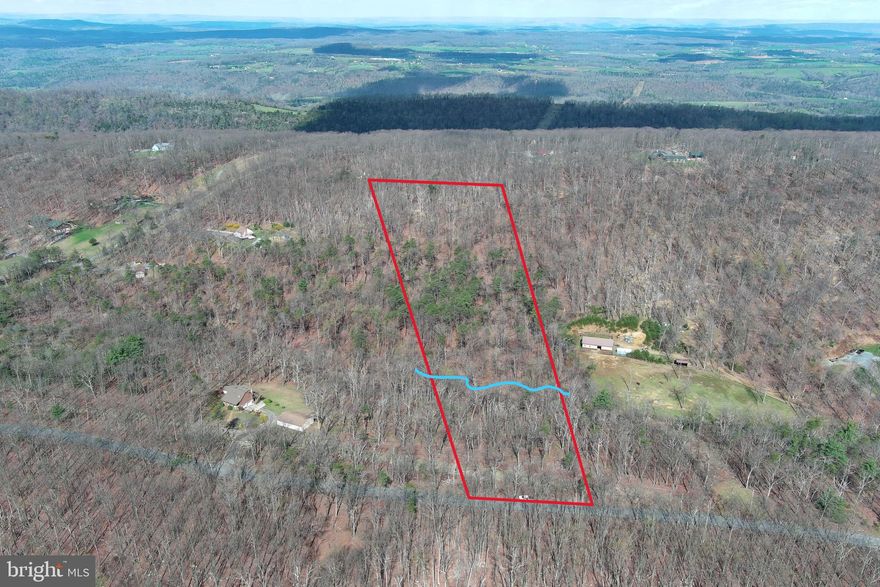 UN - RE- STRIC - TED.......7.2 UNRESTRICTED WOODED ACRES FRONTING ON QUIET PAVED COUNTRY ROAD, LESS THAN 2 MILES OFF RT 50 AND LESS THAN 30 MINUTES FROM WINCHESTER, VA. FLOWING SPRINGS AND WET WEATHER STREAM....MASSIVE HARDWOODS, PINE THICKET, BIG VIEWS FROM THE BACK. MINUSCULE INFRASTRUCTURE COSTS.....SHORT DRIVEWAY TO BUILD SITE AND ELECTRIC WITHIN 30 FT OF BUILD SITE....APPROVED PERK. BIG HOME, TINY HOME, MOBILE HOME.....HUNT, CAMP, SHOOT......NO HOA + NO RESTRICTIONS = NO PROBLEMS! PROPERTIES LIKE THIS ARE AS RARE AS A HEN'S TOOTH AND WILL DISAPPEAR FASTER THAN THAN A POPSICLE IN JULY!