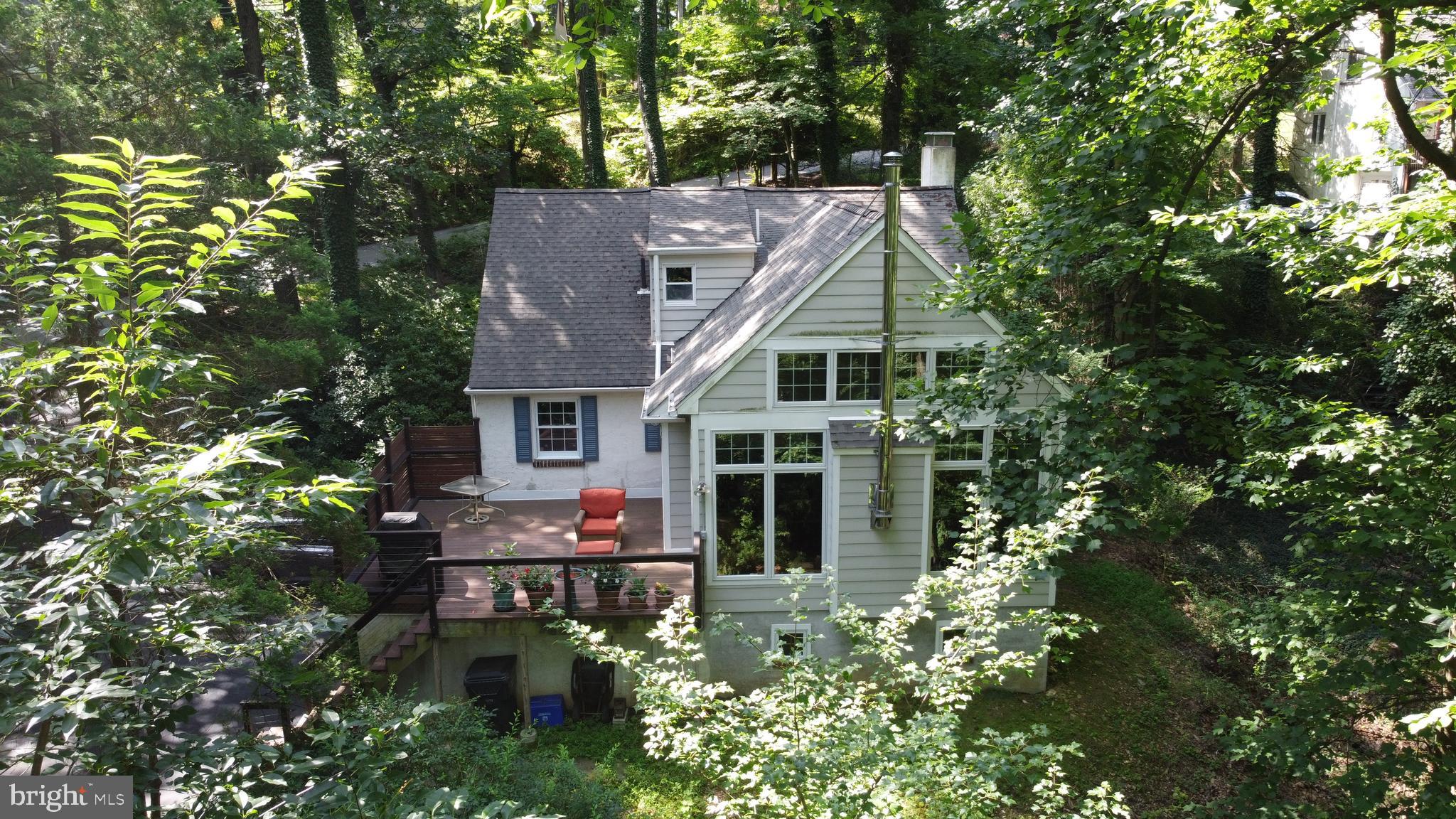 Nestled at the top of the hill in a serene natural setting, just a quick drive from the vibrant amenities of King of Prussia, this delightful 4-bedroom, 2 bath Cape-style home offers the perfect blend of privacy, comfort, and convenience. Enjoy a low-maintenance lifestyle without the burden of lawn care, all while being surrounded by picturesque seasonal views. The main level features rich walnut hardwood flooring that adds warmth and character throughout. Upon entry, you’re welcomed into a cozy living room with a classic wood-burning fireplace. The kitchen has ceramic tile floor, recessed lighting, quartzite countertops with matching peninsula and a tumbled marble backsplash. Wooden cabinetry with under-cabinet lighting completes the space, offering both functionality and style. The adjoining eat-in area offers built-in cabinetry and space for an additional dining table, creating a versatile layout. The expansive great room impresses with its 18-foot cathedral ceiling, exposed beams, and ceiling fan, all anchored by a wall of northwesterly facing floor-to-ceiling windows and a cozy wood-burning stove. From here, enjoy tranquil views of the surrounding wooded landscape, with glimpses of the distant King of Prussia skyline when the autumn leaves have fallen. Sliding doors open to a composite deck, perfect for relaxing or entertaining. The main level also includes two bedrooms, one featuring built-in shelving, and a full bathroom with ceramic tile floor and shower with ceramic and glass tile finish. The upper-level features carpet over hardwood flooring and includes two additional bedrooms and a full bathroom. This floor offers flexibility to serve as a private primary suite or accommodate separate bedrooms. The bathroom has ceramic tile flooring and a quarzite-topped vanity with undermount sink. The custom shower is adorned with ceramic tile and listellos, marble and glass enclosure, bench seating and a vaulted tile ceiling. A generously sized hallway closet complements the ample bedroom storage. The upper level features a second zone mini-split air conditioning system. The walkout basement is partially finished and offers multiple rooms that can be tailored to your lifestyle - ideal for a fitness area, game room, or additional storage space. It also includes a workshop, laundry area with cabinetry and sink, and direct access to two garages, one of which is oversized. The garage configuration helps to limit the temperature extremes during the summer and winter months within the garage areas. This well maintained and updated home is a rare opportunity to enjoy peaceful living with easy access to shopping, dining, and entertainment-an ideal retreat that doesn’t sacrifice convenience. Owner is a licensed real estate associate broker in the Commonwealth of Pennsylvania and the state of New Jersey; and a Certified General Appraiser in the Commonwealth of Pennsylvania. Floor sketch provided for reference and is deemed reliable but not guaranteed. AGENTS: READ AGENT REMARKS FOR INSTRUCTIONS.