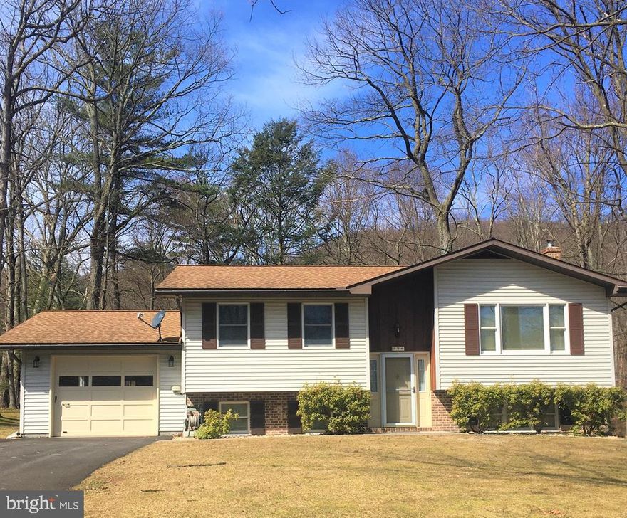 Very well maintained home in beautiful, quiet setting.  New laminate in upstairs floors, roof is approx. 5 years old.  Bath with Italian tile has entrance from bedroom and hall.  Finished family room with wood stove to supplement heat.   Framed out room in basement has potential for 3rd bedroom.   Home has recently been subdivided and taxes are estimated at this time.