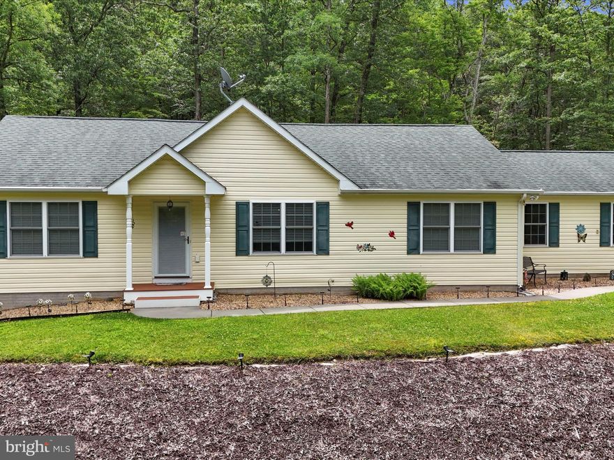 The Right Kind of Quiet. The Right Kind of Home. Some places just feel good the moment you pull in. This is one of them. Set on two wooded acres in the Bristol Springs Subdivision near Slanesville, West Virginia, this ranch-style home was built in 2012 and has been cared for with intention ever since. It offers 1,620 square feet of well-planned, one-level living—three bedrooms, two bathrooms, and just the right amount of space to live comfortably without the upkeep that weighs you down. The land here matters. Mature oaks offer shade and privacy—the kind that makes sitting on the back patio feel like a reward at the end of your day. You’re not boxed in by fences or traffic noise. You’re surrounded by trees, light, and stillness—just enough to hear the breeze move through the leaves. Inside, the home opens up in all the right places. Vaulted ceilings and an open-concept country kitchen give it room to breathe. The bar seating is perfect for coffee in the morning or catching up in the evening. A quiet den or office just off the dining area adds flexibility—it’s your space to turn into whatever you need most. Every part of this home is solid. The bathrooms are finished with care. The systems are efficient. The layout simply makes sense. No stairs. No wasted corners. No compromises. And when you need to head to town, you’re not far. Winchester, Virginia, and I-81 are an easy 40-minute drive—close enough to stay connected, far enough to feel like you’ve really gotten away. If you’re looking for a home that offers more than square footage—if you want calm, purpose, and the kind of space that feels like your own—you’ll want to see this one for yourself.