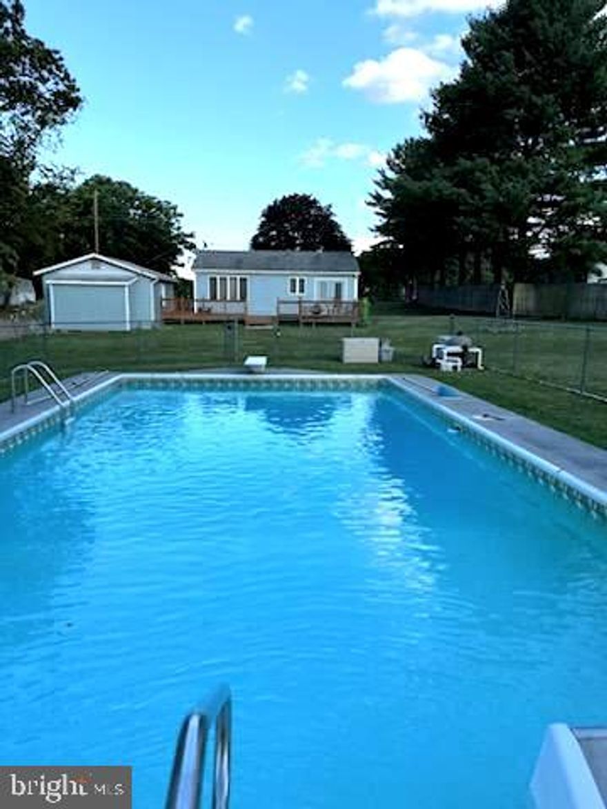 This charming 2 bedroom 1 1/2 bath  home has beautiful views from the back deck that overlooks the pool.   The kitchen and family room give you an open feeling with plenty of space. Appliances are included with this sale making it ready for you to easily move in quickly.  Has large lot on a cul-de-sac, with all paved roads, and only about 15 minute drive from Walmart shopping area. It's a terrific first time home or for a downsizing family. Shawneeland offers a nice lake with a beach area for swimming, boating and fishing, plus playground area for outdoor games or relaxing.  NO HOA with Frederick County maintaining all roads and amenities for only $660.oo per year. Frederick County trash and recycling pickup site at north entrance on Bowman Lane.