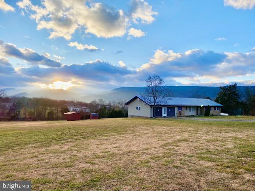 Located just outside the town of Petersburg on 2.51 unrestricted acres with beautiful western sunset views of the Smoke Hole Canyon sits this 3 bedroom, 2.5 bath ranch-style home. The home has portions of new laminate flooring, a newer metal roof, and forced air propane heat with central air conditioning. The property features a large backyard with a small pond.