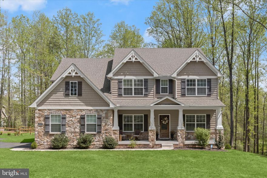 Welcome to 307 Red Meadows Court, a stunning Colonial residence gracefully set on a peaceful 2.09-acre homesite in the sought-after community of Temples Delight. Surrounded by serene wooded views, this exceptional property offers the perfect blend of refined living and tranquil outdoor spaces, highlighted by an expansive deck, custom patio, built-in pergola, fenced garden area, attached two-car garage, and a welcoming covered front porch.
Step inside to discover beautifully appointed interiors where luxury vinyl plank flooring, oversized windows, classic moldings, and a soft neutral palette create a timeless and elegant atmosphere throughout the main living areas. The inviting foyer is flanked by formal living and dining rooms, ideal for entertaining and everyday gatherings.
At the heart of the home, the chefs eat-in kitchen is thoughtfully designed with quartz countertops, decorative backsplash, stainless steel appliances, a center island with breakfast bar and pendant lighting, a pantry, and a bright breakfast room with direct access to the deck, making indoor-outdoor living effortless. Just off the kitchen, the family room offers a warm and comfortable retreat anchored by a cozy fireplace. A functional mudroom with garage access and a powder room completes the main level.
Upstairs, the primary suite serves as a private sanctuary, featuring a tray ceiling, two walk-in closets, and a spa-inspired en-suite bath with separate vanities, a slipper soaking tub, and a walk-in shower. Three additional spacious bedrooms each with walk-in closets along with a full hall bath and a convenient laundry room complete the upper level.
The finished lower level extends the living space with a recreation room that opens directly to the custom patio, offering peaceful wooded views and an ideal setting for relaxation or entertaining. A full bath and abundant storage complete this impressive level.
Blending elegant interiors, thoughtful design, and beautiful outdoor living, 307 Red Meadows Court presents a remarkable opportunity to enjoy refined living in a picturesque setting.