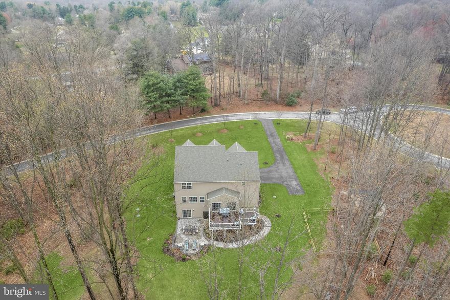 Welcome to 307 Red Meadows Court, a stunning Colonial residence gracefully set on a peaceful 2.09-acre homesite in the sought-after community of Temples Delight. Surrounded by serene wooded views, this exceptional property offers the perfect blend of refined living and tranquil outdoor spaces, highlighted by an expansive deck, custom patio, built-in pergola, fenced garden area, attached two-car garage, and a welcoming covered front porch.
Step inside to discover beautifully appointed interiors where luxury vinyl plank flooring, oversized windows, classic moldings, and a soft neutral palette create a timeless and elegant atmosphere throughout the main living areas. The inviting foyer is flanked by formal living and dining rooms, ideal for entertaining and everyday gatherings.
At the heart of the home, the chefs eat-in kitchen is thoughtfully designed with quartz countertops, decorative backsplash, stainless steel appliances, a center island with breakfast bar and pendant lighting, a pantry, and a bright breakfast room with direct access to the deck, making indoor-outdoor living effortless. Just off the kitchen, the family room offers a warm and comfortable retreat anchored by a cozy fireplace. A functional mudroom with garage access and a powder room completes the main level.
Upstairs, the primary suite serves as a private sanctuary, featuring a tray ceiling, two walk-in closets, and a spa-inspired en-suite bath with separate vanities, a slipper soaking tub, and a walk-in shower. Three additional spacious bedrooms each with walk-in closets along with a full hall bath and a convenient laundry room complete the upper level.
The finished lower level extends the living space with a recreation room that opens directly to the custom patio, offering peaceful wooded views and an ideal setting for relaxation or entertaining. A full bath and abundant storage complete this impressive level.
Blending elegant interiors, thoughtful design, and beautiful outdoor living, 307 Red Meadows Court presents a remarkable opportunity to enjoy refined living in a picturesque setting.