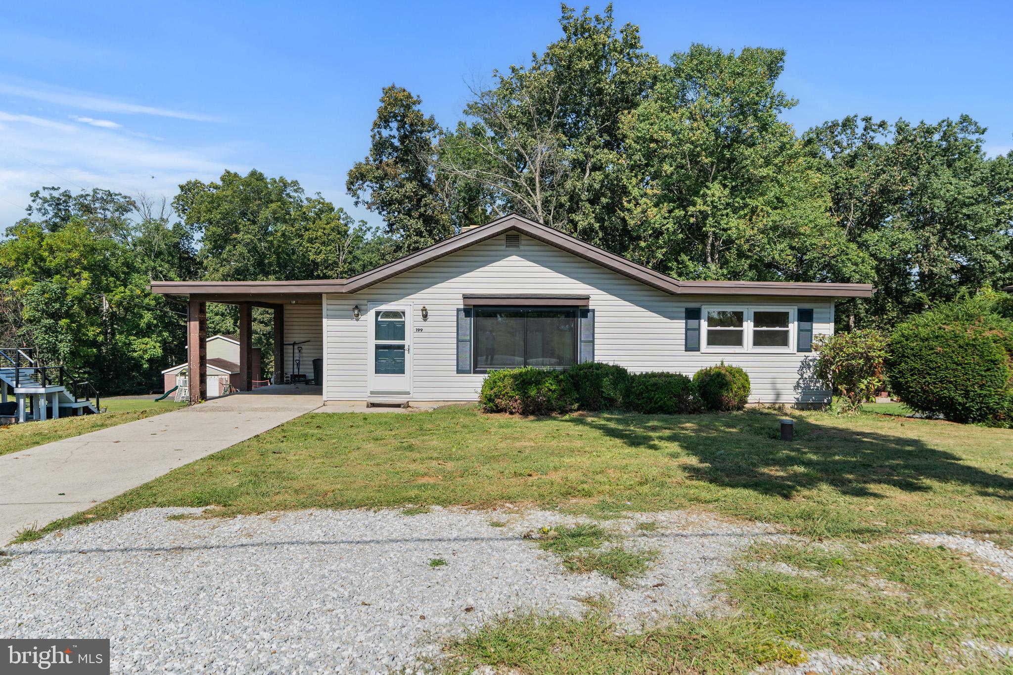 Welcome home to this charming rancher set on a peaceful, partially wooded .84-acre lot just minutes from historic Gettysburg. Inside, the open floorplan offers warmth and flexibility. The spacious living room features hardwood flooring, a large picture window that fills the space with natural light, and a classic brick wood-burning fireplace—perfect for cozy evenings.
The home includes a dining area that could easily double as a 4th bedroom or home office, giving you options to fit your lifestyle. You’ll find three bedrooms, including the primary suite with its own full bath and two closets. Both bathrooms are full baths, and hardwood floors extend throughout the living spaces and bedrooms. All windows have been replaced for efficiency and peace of mind.
The walk-out basement adds even more space, with a recreation room anchored by a second wood-burning fireplace, plus a laundry area with washer, dryer and utility sink. Step out back to enjoy your spacious back yard and wooded view.