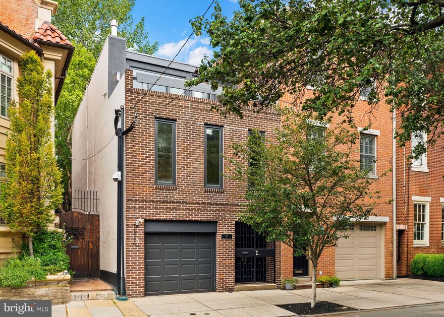 Located in the highly sought-after Meredith School Catchment with a private attached garage with covered off-street parking! This beautifully renovated Contemporary/Mid-Century-Modern home built in 1965 sits on a very desirable block in the always-in-demand Queen Village neighborhood—where homes like this rarely come to market. Featuring 3 bedrooms, 2 full bathrooms, and an attached 1-car garage, a large private fenced backyard, and a front walkout roof deck, this property offers a rare combination of style, comfort, and lots of outdoor space. The home boasts a stunning private rear yard oasis—professionally landscaped and hardscaped by Liberty Tree & Landscape Management—with flowering beds, mature Magnolia, River Birch, and Weeping Japanese Maple trees. The outdoor space is enhanced by Bluestone and Old World Brick patios, walkways, fieldstone garden walls capped with Bluestone for additional seating, and elegant landscape lighting. This expansive yard also includes an additional connected lot (Tax ID 022029810), creating a truly rare outdoor retreat in the city. Inside, the layout is open and bright, with a front walkout roof deck, a cozy gas fireplace with a stone surround and hearth, and a first-floor laundry room. The home is filled with thoughtful updates, including a cook’s kitchen with Oakmoss solid wood cabinetry, Brushed Brass hardware and fixtures, stone countertops, stainless steel backsplash and appliances (5-burner gas range/convection oven, microwave, refrigerator/freezer, dishwasher, disposal), double-bowl sink, and LVP flooring. The first full bathroom features a walk-in shower with glass door, Rainhead, stone countertops, floor and wall tile, Brushed Brass fixtures, recessed lighting, and a stylish vanity. The second full bathroom offers a combination bathtub and shower with Rainhead, dual sinks, skylight, Brushed Brass fixtures, ceramic and stone tile, and custom lighting. Additional upgrades and features include Low-E casement and double-hung windows, sliding glass doors to the yard, roof, electric, Carrier gas furnace and central air HVAC systems, and an AO Smith gas hot water heater. The entire interior and exterior were just professionally painted. Original hardwood floors, stairs, and railings have just been professionally refinished, and all exposed brick walls have been restored and painted white. Other highlights include an office/workstation area, LED recessed lighting throughout, Matte Black exterior lighting and modern ceiling fans, custom closet organization, restored double wood front doors with slate foyer flooring, an insulated garage with automatic opener and shelving, wrought iron front door gates, a front door smart lock, hardwired fire, smoke, and security systems, updated masonry, and brick pointing. The home is filled with natural light, generous storage, and abundant space to spread out both indoors and out. Enjoy walkability to top-rated schools, restaurants, coffee shops, cafes, boutiques, parks, hospitals, and universities. This is truly a rare opportunity—a “needle in a haystack” in Queen Village and the City of Philadelphia. With easy access to Center City, Delaware Avenue, I-95, I-676, I-76, major bridges, stadiums, 30th Street Station, and Philadelphia International Airport, convenience is unmatched. With the Philadelphia Homestead Exemption, estimated 2025 property taxes are just $10,864.