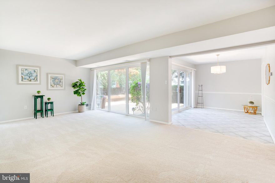 Fabulous, updated END UNIT townhome with loads of light, privacy & hardwoods throughout!  Eat-in kitchen has hard surface counter tops, stainless wall oven, stainless refrigerator, dishwasher and cooktop. Bar-height breakfast bar conveys.  Spacious powder room off foyer. Expansive, sunny living room with sliding glass doors to spacious, fenced brick patio & parquet hardwood flooring under new carpet!  Separate dining room with on-trend chandelier, chair rail & sliding glass doors to deck/patio.  Upper level has 3 spacious bedrooms, with hardwoods, updated light fixtures and nice-sized closets.  Primary bath has floor-to-ceiling tile surrounding glass enclosed shower. Updated light fixtures throughout and freshly painted!  Assigned covered carport conveys with this home, as well as 1 unassigned parking spot. Convenient in and out, easy access to parking spot through fenced patio. Walk to Reston Town Center and enjoy shops, restaurants, theaters, ice skating; as well as the Silver Line.  Enjoy miles of walking trails, pools, parks, tennis courts, and all that Reston Association has to offer. Easy access to Dulles airport, Tysons, the Beltway.