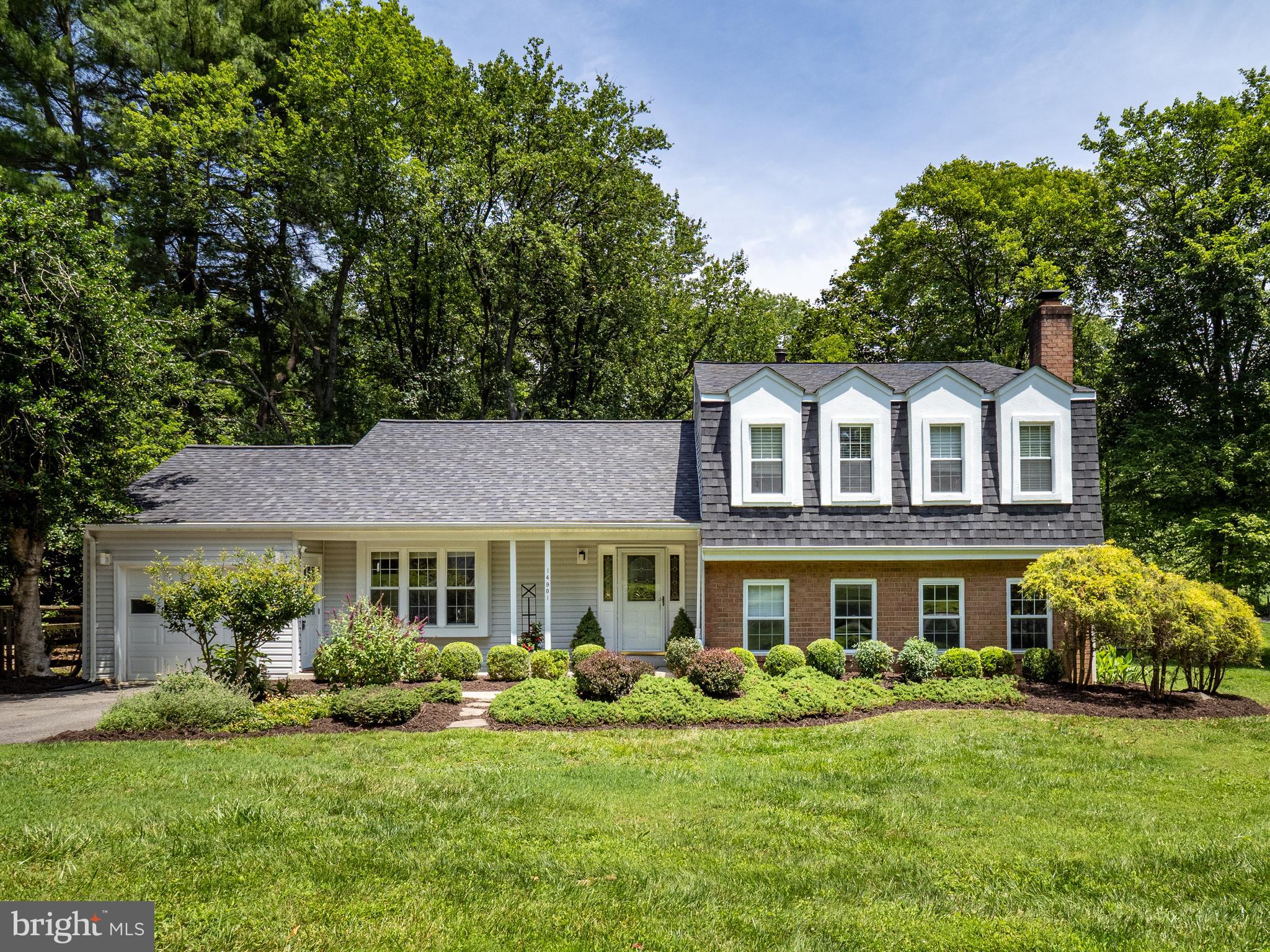 Set on a large leafy lot backing to parkland, this home has great space and thoughtful improvements. Stepping through the front porch into the foyer, you're greeted with bright living spaces and oak hardwood flooring that extend through the formal spaces. The formal rooms feature recessed lighting and two walls of triple windows. The kitchen is a real "wow" space! Fully renovated by the current owner, it features premium hardwood custom cabinetry, granite countertops, contemporary glass tile backsplash and tile flooring. This space was opened up to the dining room adding a bar and workspace. The family room is flooded in natural light and features premium engineered flooring and a wood-burning fireplace. A bedroom/office, renovated full bath and huge utility room is also on this level. The upper level has four bedrooms and a renovated hall bath with marble tile flooring and contemporary glass tile accents. The primary suite also has a renovated full bath and a walk-in closet. It has a wall of built-in wardrobes for even more space. All bedroom closets feature custom closet organizers. The lot is an oasis with an oversized back deck and a huge, fenced back yard. Unlike most homes in the neighborhood, the owners replaced the oil heating with natural gas. The entire home has been freshly painted, and the roof is only six years old. This is a wonderful place to call home.