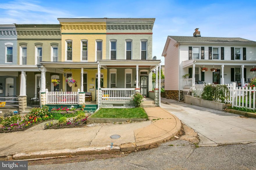 Charming Hampden home! Bright, spacious end row home has perfect blend of craftsman detail and modern updates. Large open floor plan features exposed brick, decorative fireplace, kitchen with upgraded stainless steel appliances and granite countertop. Convenient first floor 1/2 bath and laundry. Hardwood floors on main level and new carpet upstairs. Large back patio and welcoming porch perfect for entertaining. Many homeowner upgrades include new roof and gutters, french drains in basement. Easy parking only 2 blocks from the Avenue, walking distance to everything Hampden has to offer. Schedule your showing today!