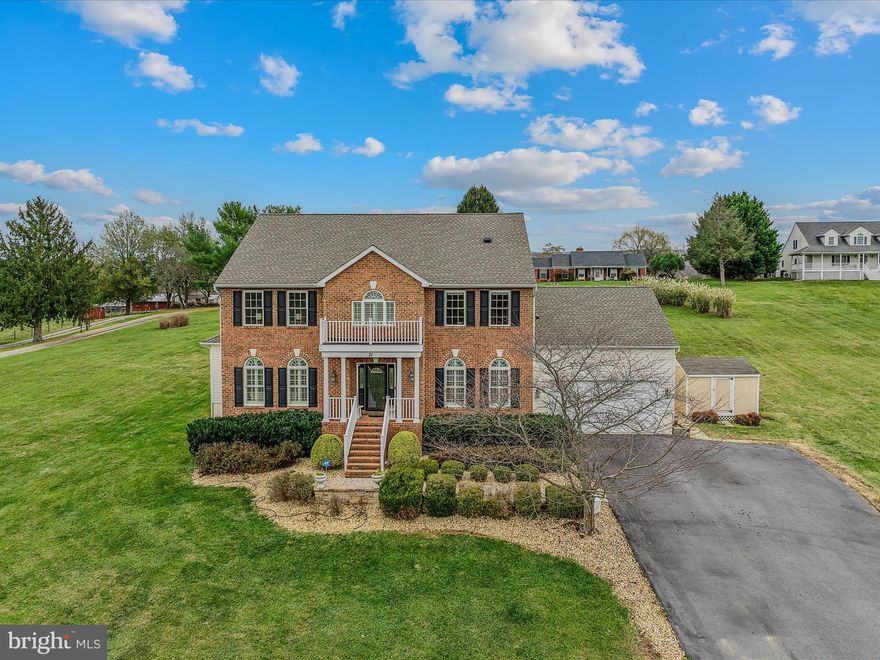 Step into this impressive, custom-built, two-story brick-front home. Nestled on a spacious 2-acre lot with minimal community restrictions, this six-bedroom home offers access to the Shenandoah River while combining rural tranquility with convenient commuter access, just a short drive from Northern Virginia.  The main level opens with a grand entryway featuring a curved staircase and flows seamlessly into an inviting layout. The luxurious primary suite on this floor offers a modern flare with a custom panel wall design, quartz counters & tile flooring. The primary bath also features a soaking tub, a separate tiled shower, and a large walk-in closet—your perfect personal retreat. A private home office is adjacent to the primary suite, which is ideal for remote work or study. Much of the main level features hardwood flooring, which adds warmth and sophistication to the space while creating a seamless flow from room to room. The formal dining and living rooms offer additional gathering areas, and the family room serves as a cozy retreat with a gas fireplace and access to the rear deck and patio. At the heart of the home is a beautifully designed kitchen equipped with a gas cooktop, double oven, center island, and breakfast nook, providing both functionality and elegance. The upper level features two full bathrooms and five spacious bedrooms with large closets, providing ample space for sleep and play. This design prioritizes convenience and privacy, offering comfortable accommodations for family or guests. The partially finished basement provides versatility with a large recreational room and a multi-purpose room, making it ideal for a home gym, crafting, or homeschooling. A large portion of the basement is left unfinished, allowing for storage or future expansion. The outdoor spaces are perfect for relaxing or entertaining friends and family and have a fantastic view. The property also includes an oversized two-car garage, a large detached shed for additional storage, and an exterior dedicated electrical RV hookup. Experience the best of West Virginia living with lower property taxes, a slower pace of life, and more affordable real estate, all while remaining conveniently close to neighboring states.