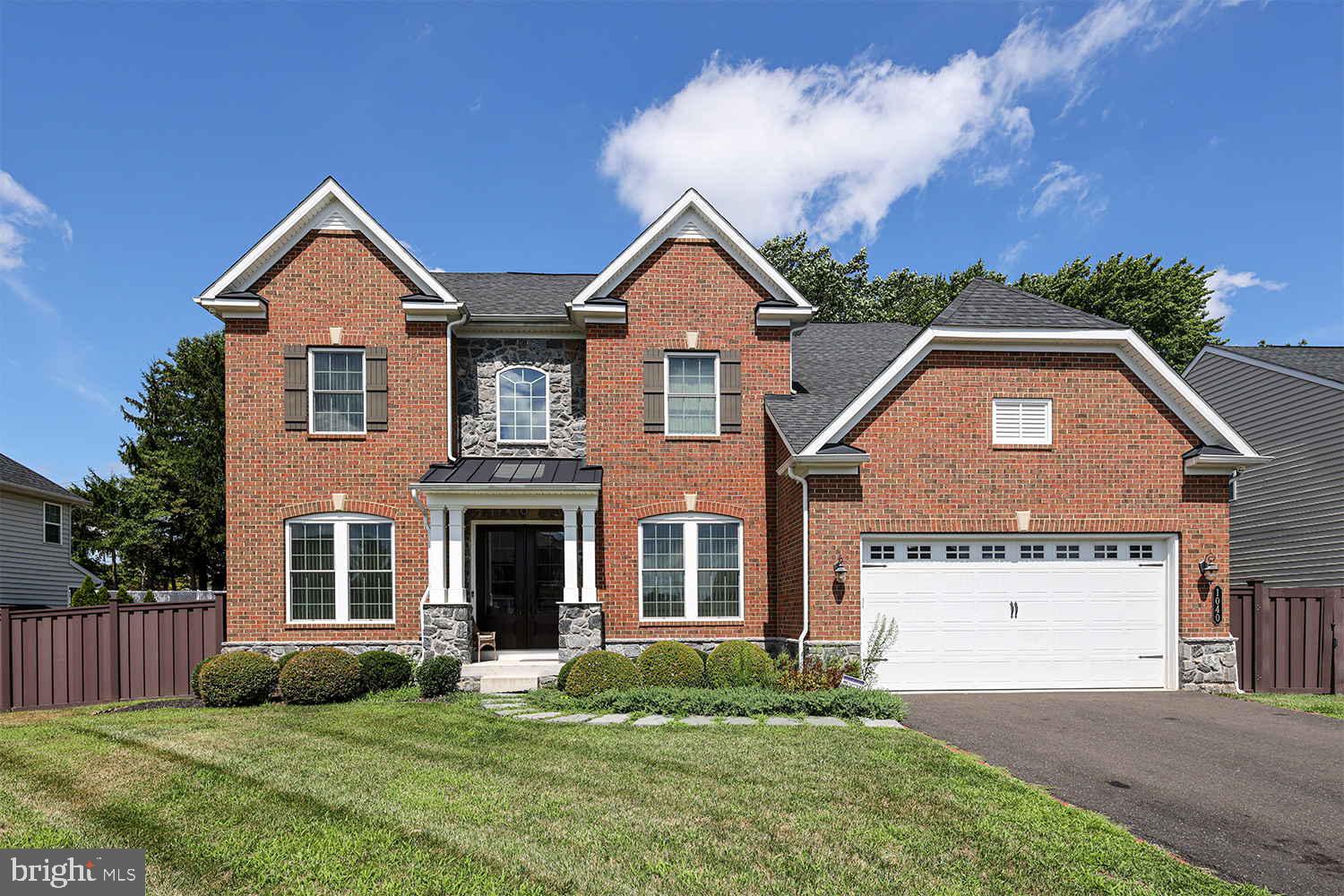 Welcome home to Mill Creek Estates. 1040 School Lane is a gorgeous exclusive Empress II estate model that offers an incredible floor plan showcasing timeless elegance - where practical design meets graceful luxury. Expansive 10 foot ceilings on the main level greet you as you walk into the open, airy foyer with beautiful hardwood floors and elegant turned staircase with iron spindles and solid oak railing . Glass French doors lead into a private office/study room that fills with natural light. A formal living room is charmed by the continued wood floors, a window lined alcove, wide crown molding and recessed lighting. Formal dining room boasts a tray ceiling with layered crown moldings. The dining room provides drama with a tray ceiling and bay window. The gourmet kitchen is sophisticated with choice designer upgrades. You will love a big center work island and a walk-in pantry, upgraded 42"cabinets, granite, stainless appliances and hardwood flooring. The family room opens to a fireplace and allows for varied furniture arrangements. A powder room, mudroom with great organizational space and the entry to the two-car garage complete this level. The upper level features 4 bedrooms. The large master suite is highlighted by a tray ceiling with elegant lighting fixture, includes a walk-in closet and a sitting area, private bath has a luxurious feel with a deep soaking tub, dual vanities, a large shower enclosed with a heavy glass door and a water closet. There are conveniently located laundry room and common bath with double vanity on this floor. Lower level features 5th bedroom and a hidden gem -walk in customized closet with great organization for a fashionista. Basement offers multi-functional space that might be used as an entertainment room where you can find another extra room/gym/office/ storage . Huge deck is accessible from the kitchen and is made of Trex materials and overlooks well-manicured fenced yard. This move-in ready home is in a great location surrounded by a quiet neighborhood, close to popular parks, schools, restaurants, shopping, regional railroad, I-95, 232, 611 and the PA Turnpike! Call for your private showing today