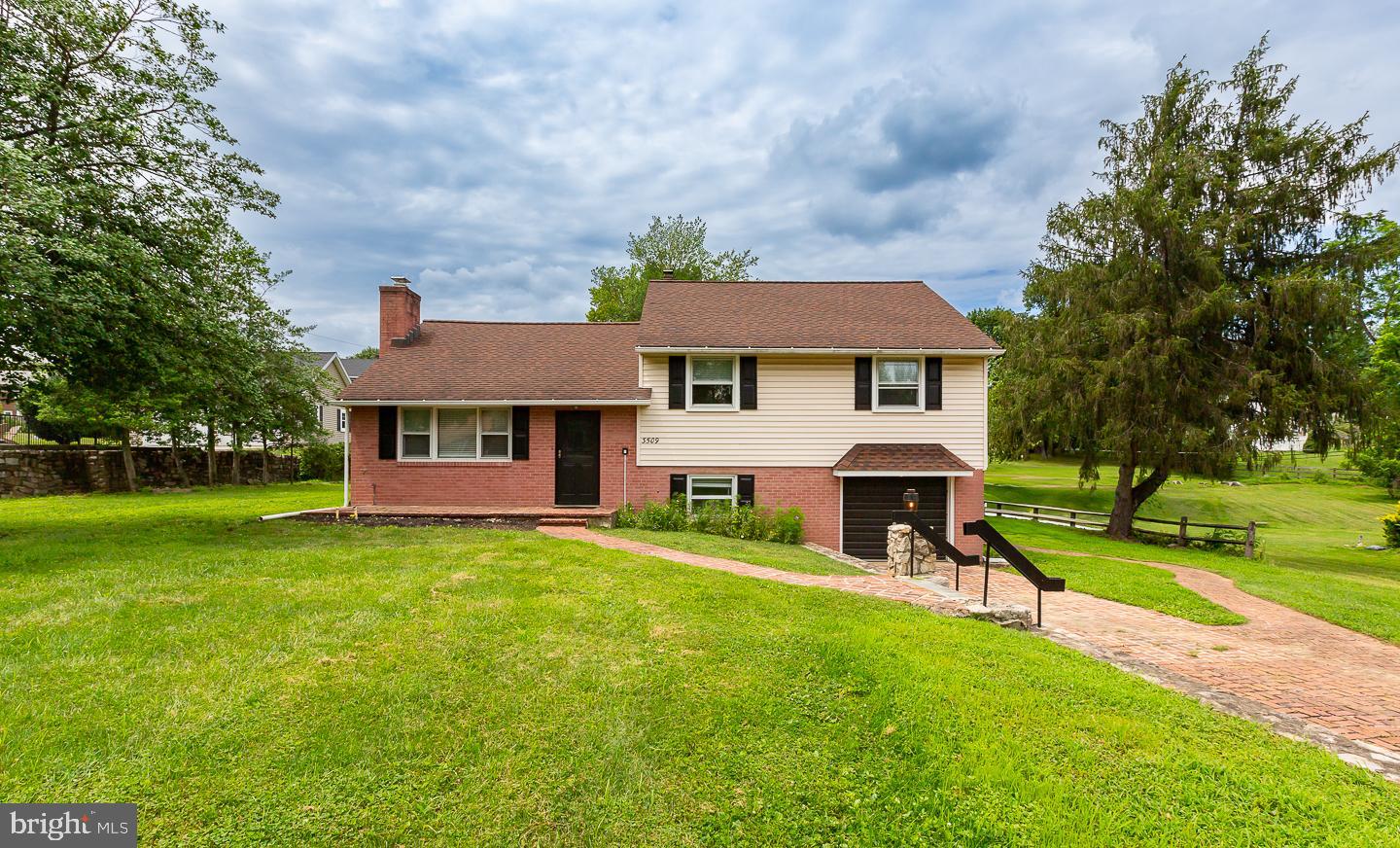Professional Photos to come! Step into this beautifully updated brick split-level home that blends classic charm with today’s style. This 3 bedroom (potentially 5) home is ready for its next occupants. Featuring brand new flooring throughout and an open floor plan perfect for everyday living and entertaining. This home boasts lots of natural sunlight, offers a wood burning fireplace and a farmhouse feel with the panel walls. The fully renovated kitchen boasts modern finishes, sleek quartz countertops, and plenty of of space for entertaining. The finished attic offers spacfe that is great for hanging out, watching a movie - you may even convert this space into an office or a guest room. The lower level is complete with vinyl floors, an area for entertaining, a half bath, laundry and a crawl space. With thoughtful updates and timeless brick exterior, this home offers both comfort and character in every corner. The yard is large in size and could be a backyard oasis. Don’t miss your chance to lease a move-in ready gem in a sought after neighborhood. It is closely located near the New Town Center, major roadways, shopping and schools.